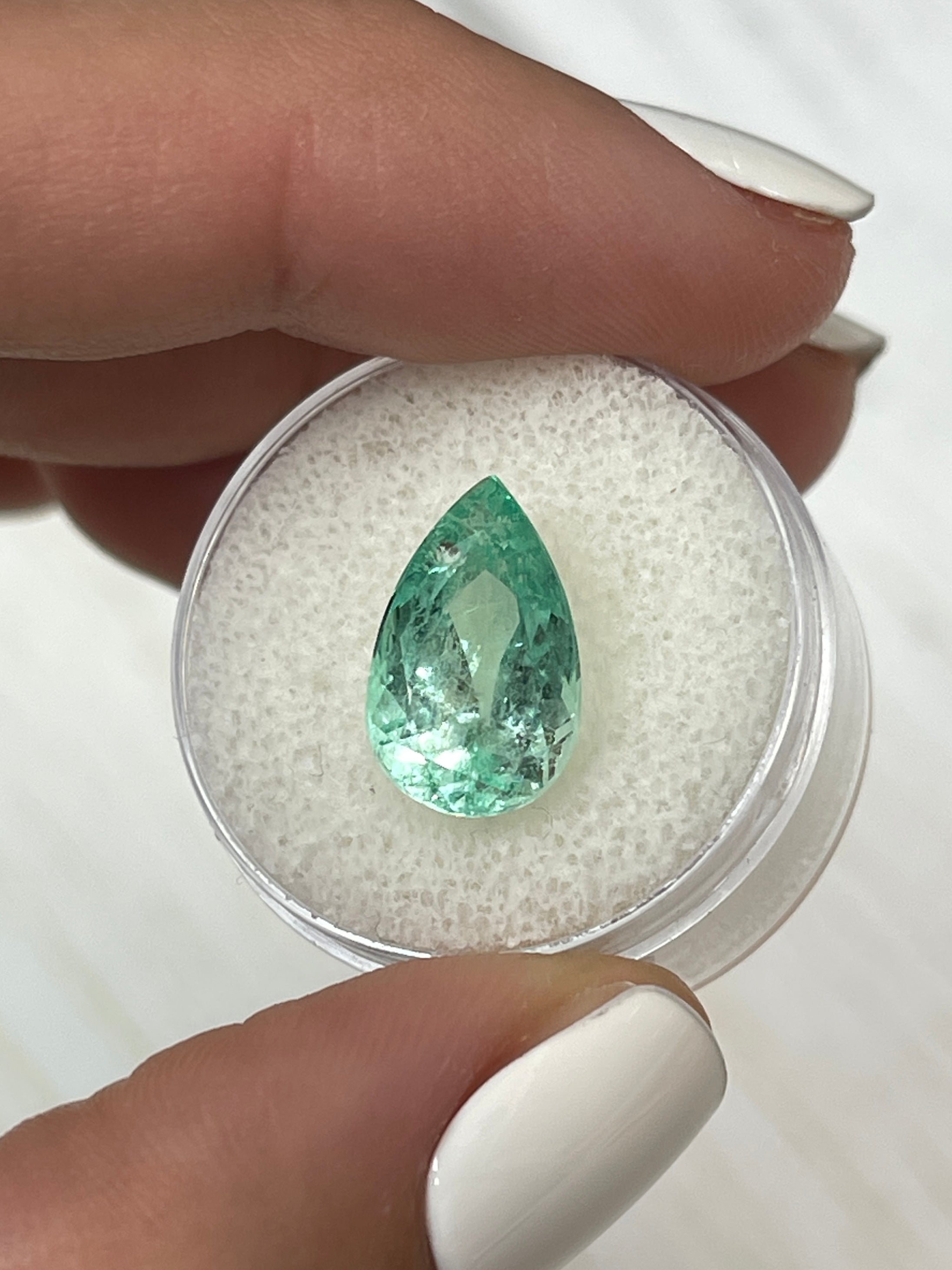 Light green 5.57 carat Colombian emerald loose gemstone in pear cut, natural and glowy, from JR Colombian Emeralds.