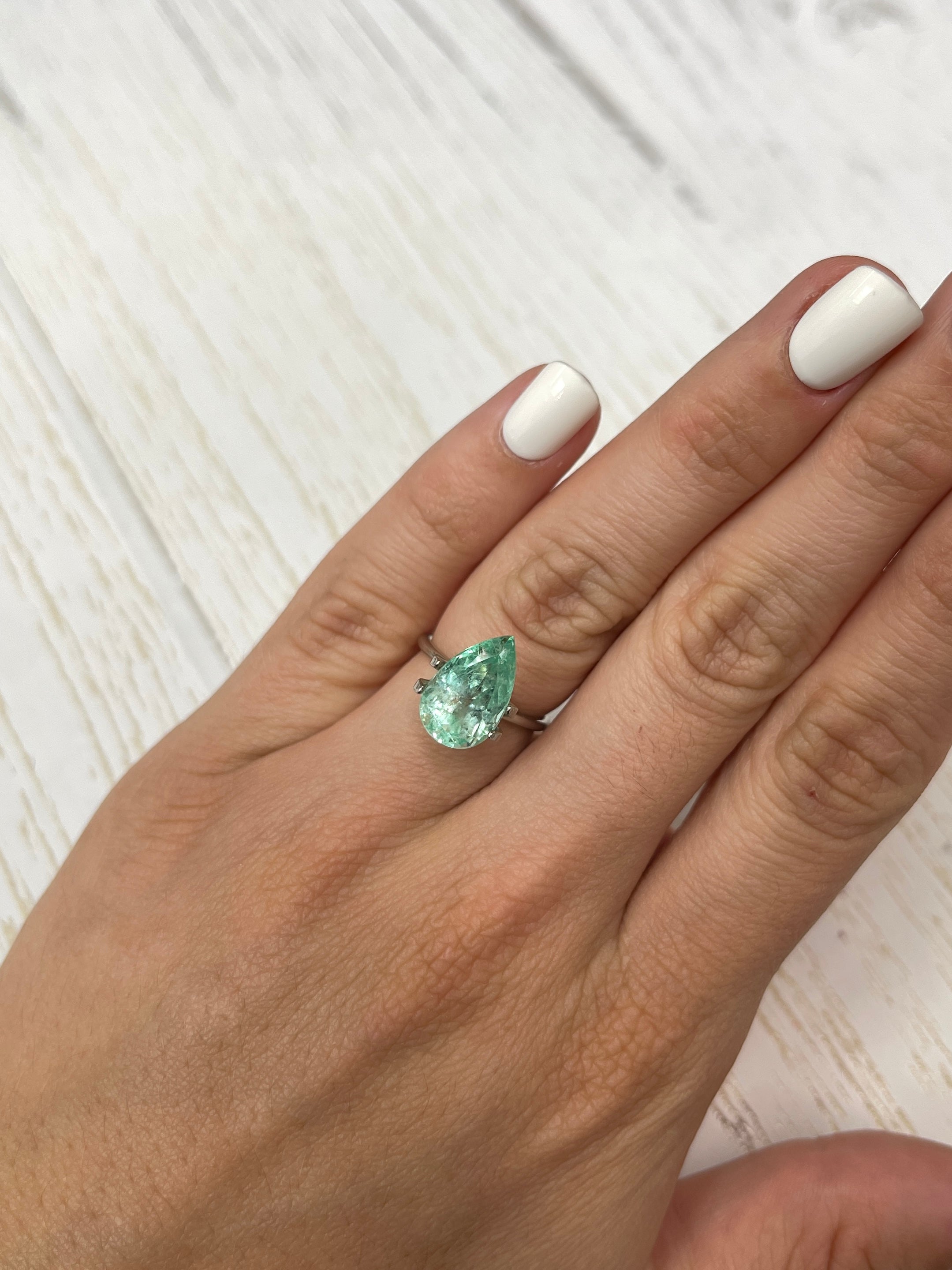 Natural light green Colombian emerald in pear cut, 5.57 carats, from JR Colombian Emeralds, showcasing its vibrant color and clarity.