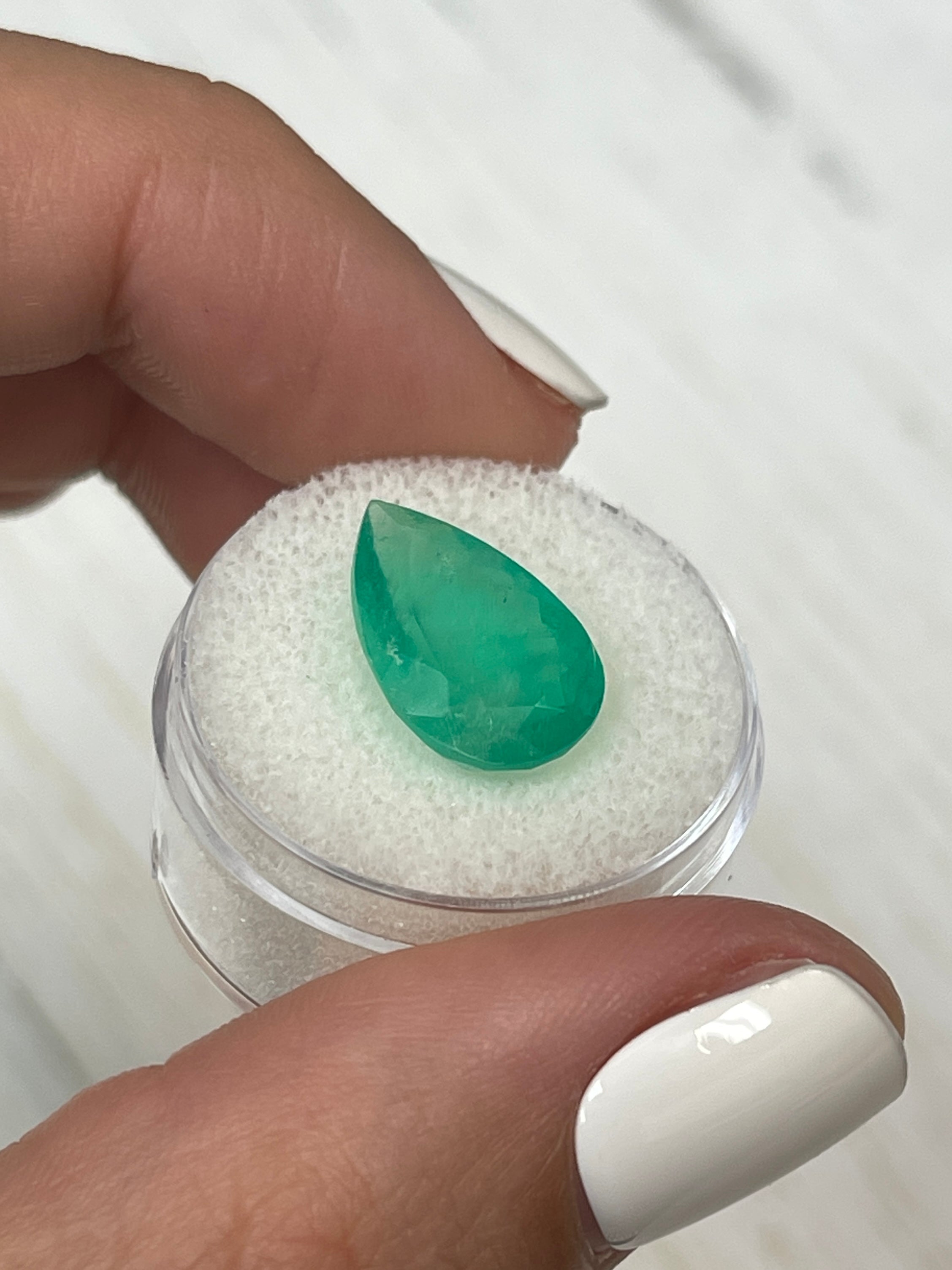 5.63 carat apple green natural Colombian emerald in pear cut, loose gemstone from JR Colombian Emeralds.