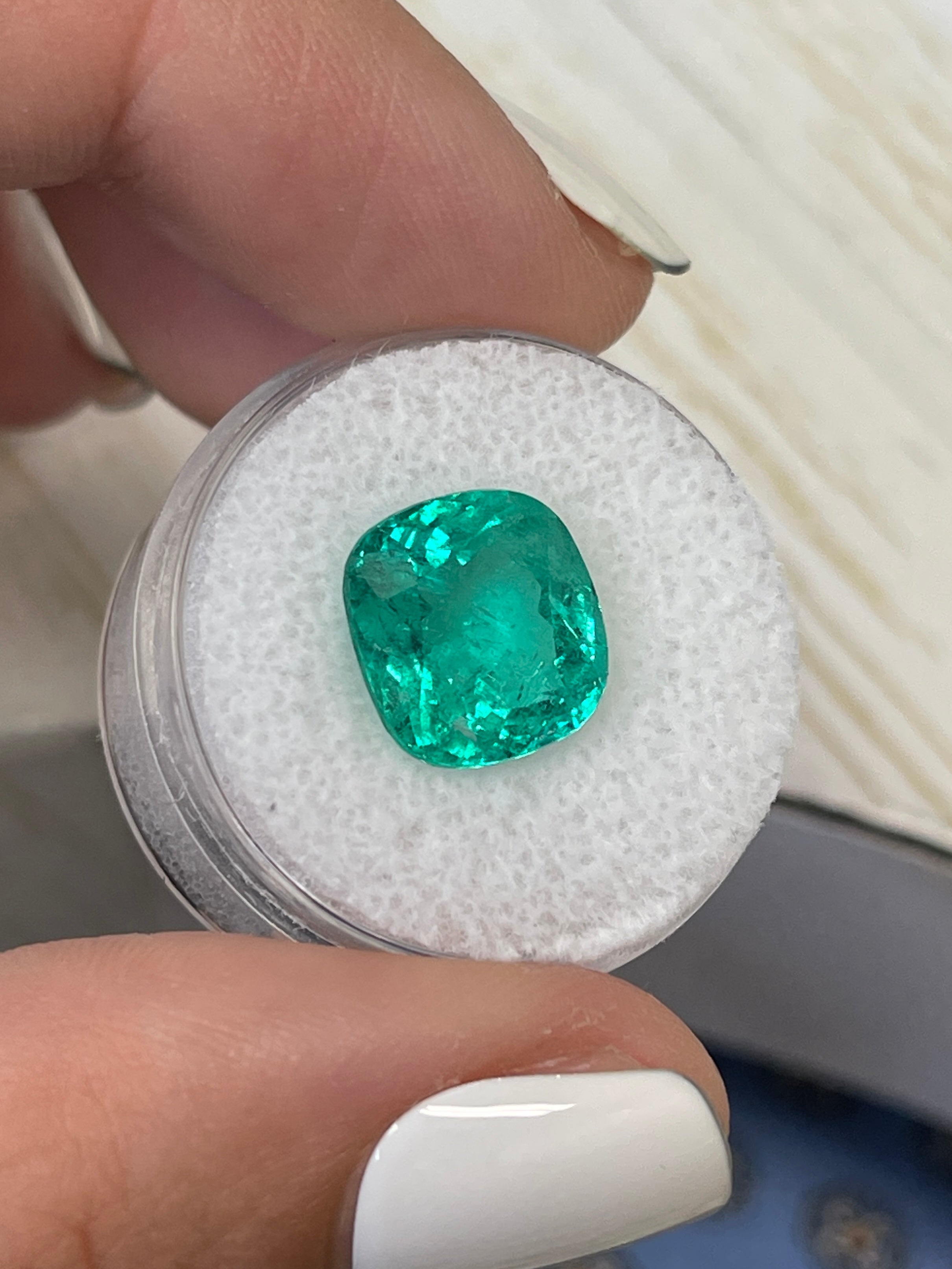 Fine bluish green 5.80 carat Colombian emerald loose cushion cut gemstone from JR Colombian Emeralds with natural clarity and vibrant color.