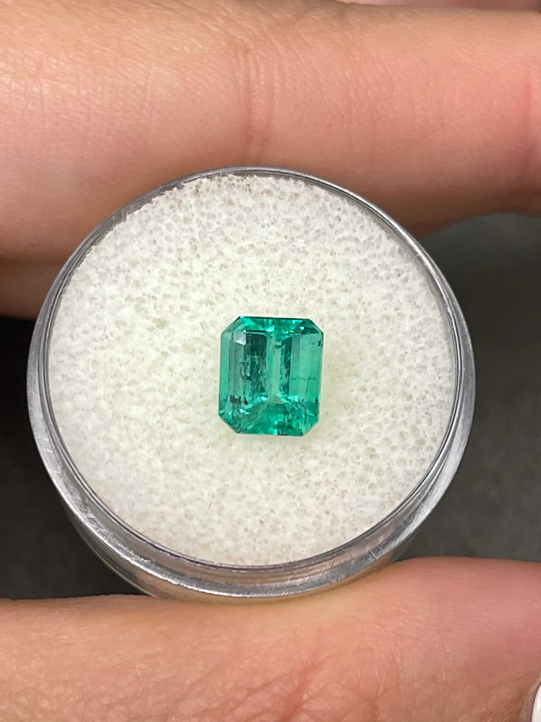 Bright bluish green 1.69 carat Colombian emerald loose gemstone in emerald cut, set in a gold solitaire ring by JR Colombian Emeralds