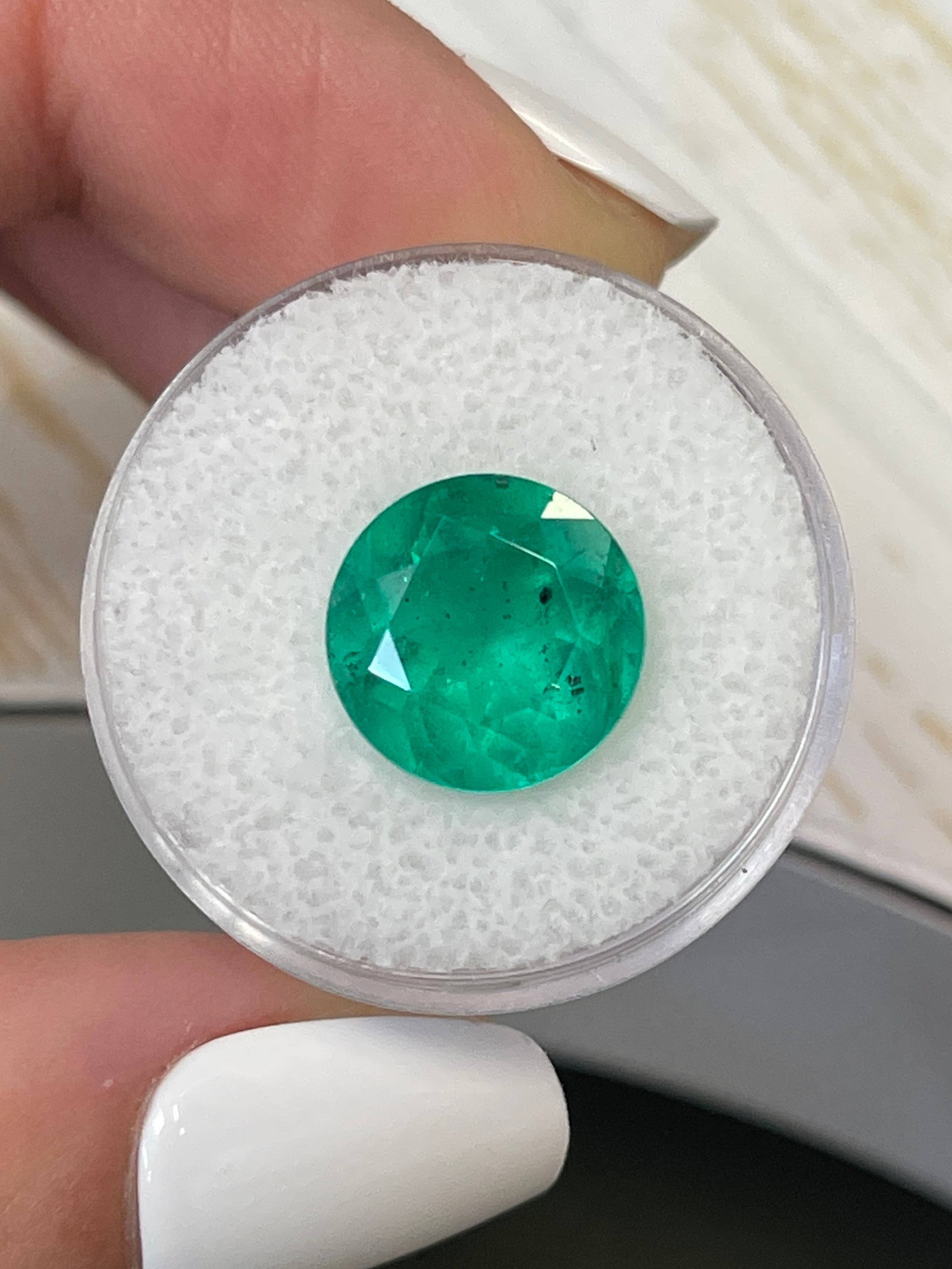 6.16 carat freckled green Colombian emerald, round cut, natural loose gemstone from JR Colombian Emeralds