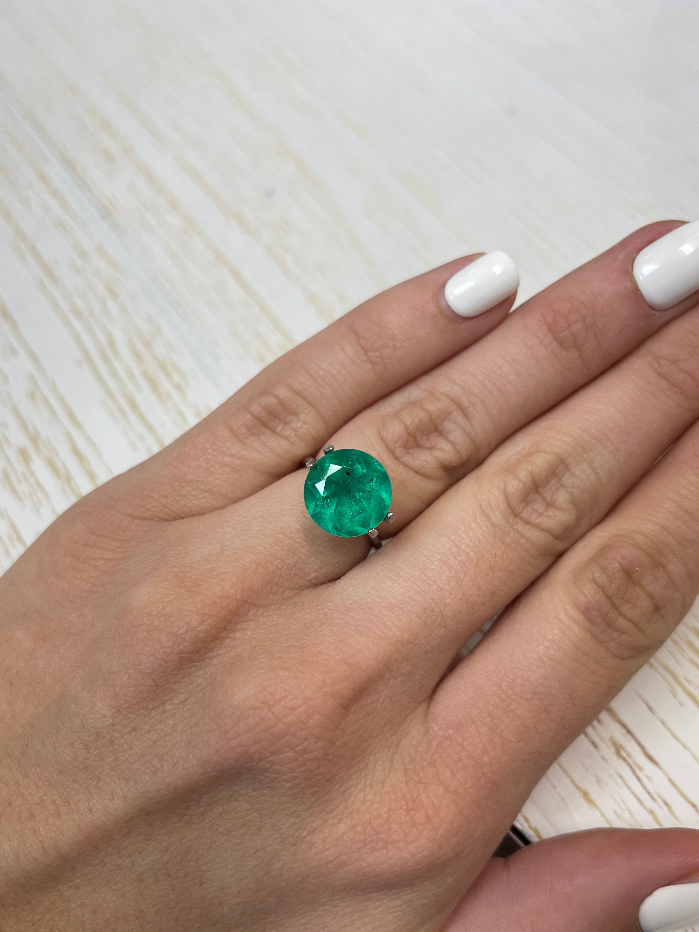 6.16 carat natural round Colombian emerald with freckled green coloration, loose gemstone from JR Colombian Emeralds.