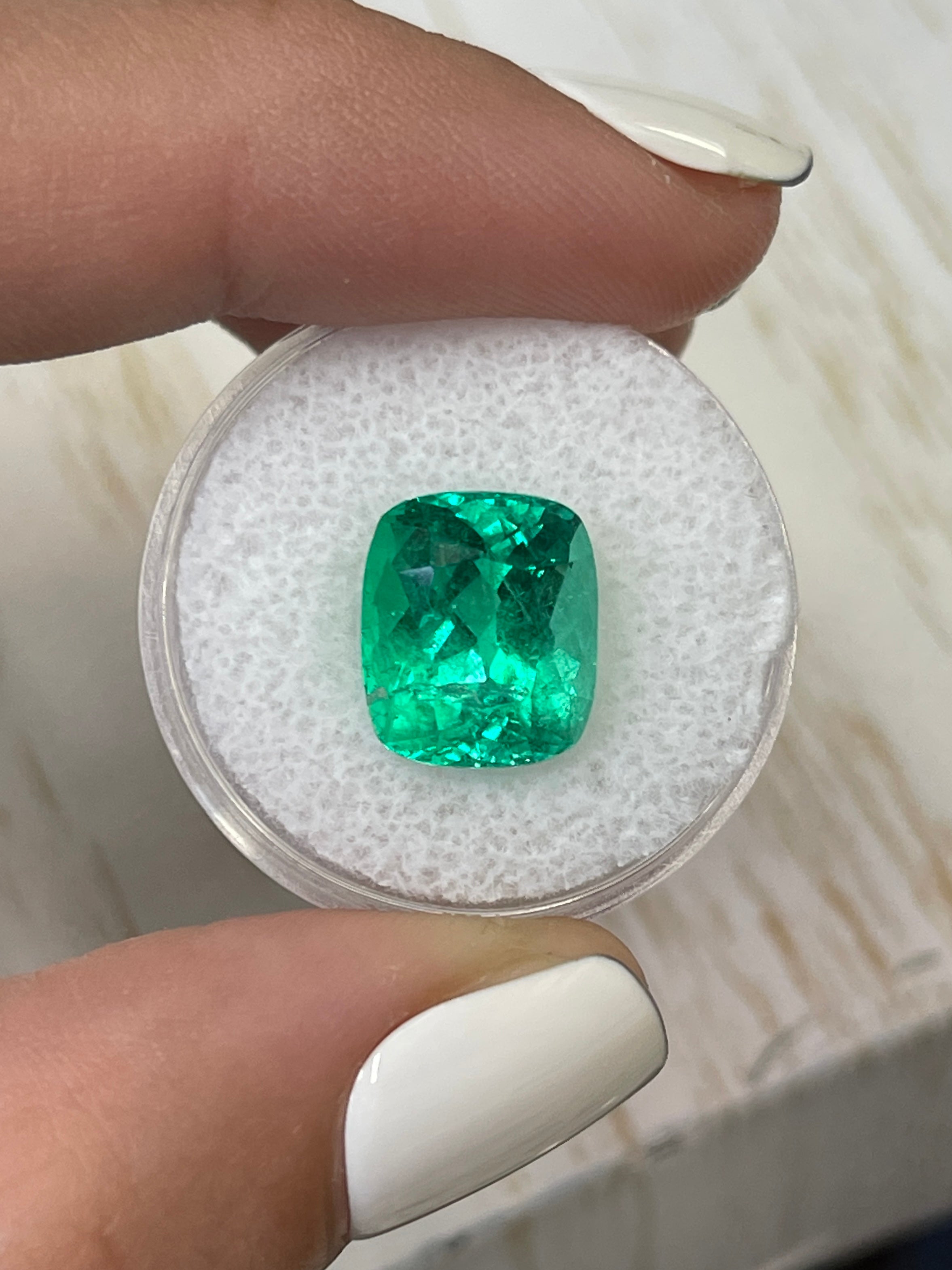 Natural 6.17 carat Colombian emerald loose gemstone, cushion cut with intense green color and minor to moderate oil treatment.