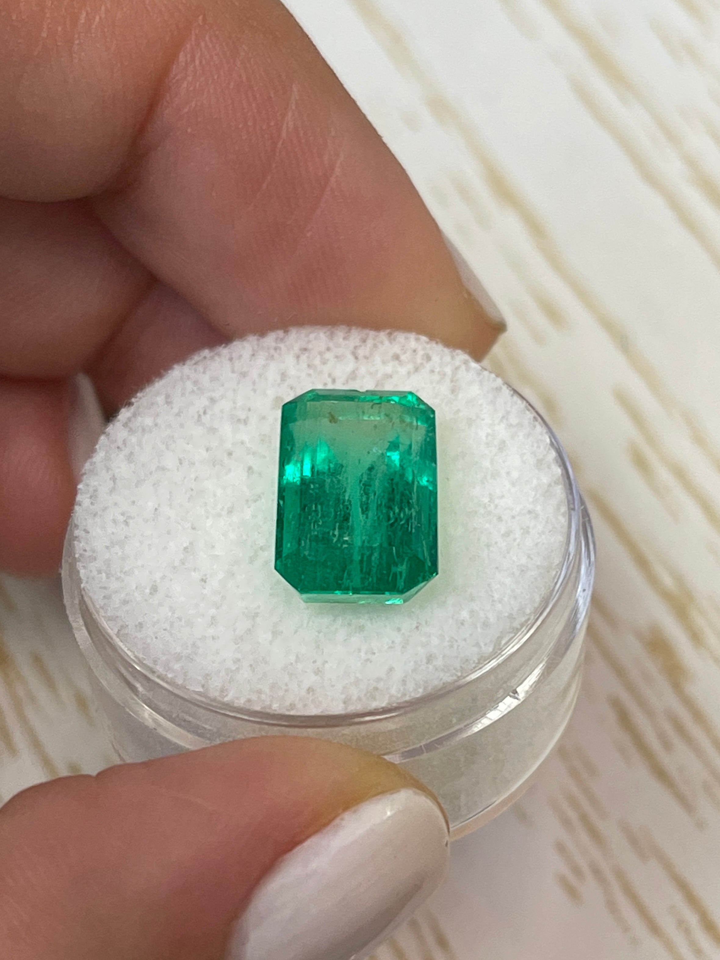 6.22 carat bluish green Colombian emerald cut loose gemstone from JR Colombian Emeralds, showcasing a vibrant emerald cut.
