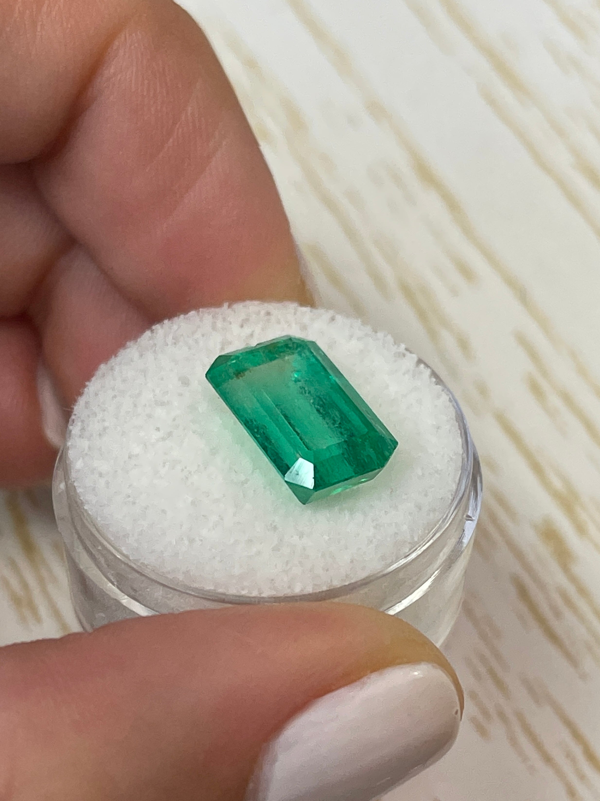 Bluish green 6.22 carat Colombian emerald cut loose gemstone from JR Colombian Emeralds, showcasing vibrant color and clarity.