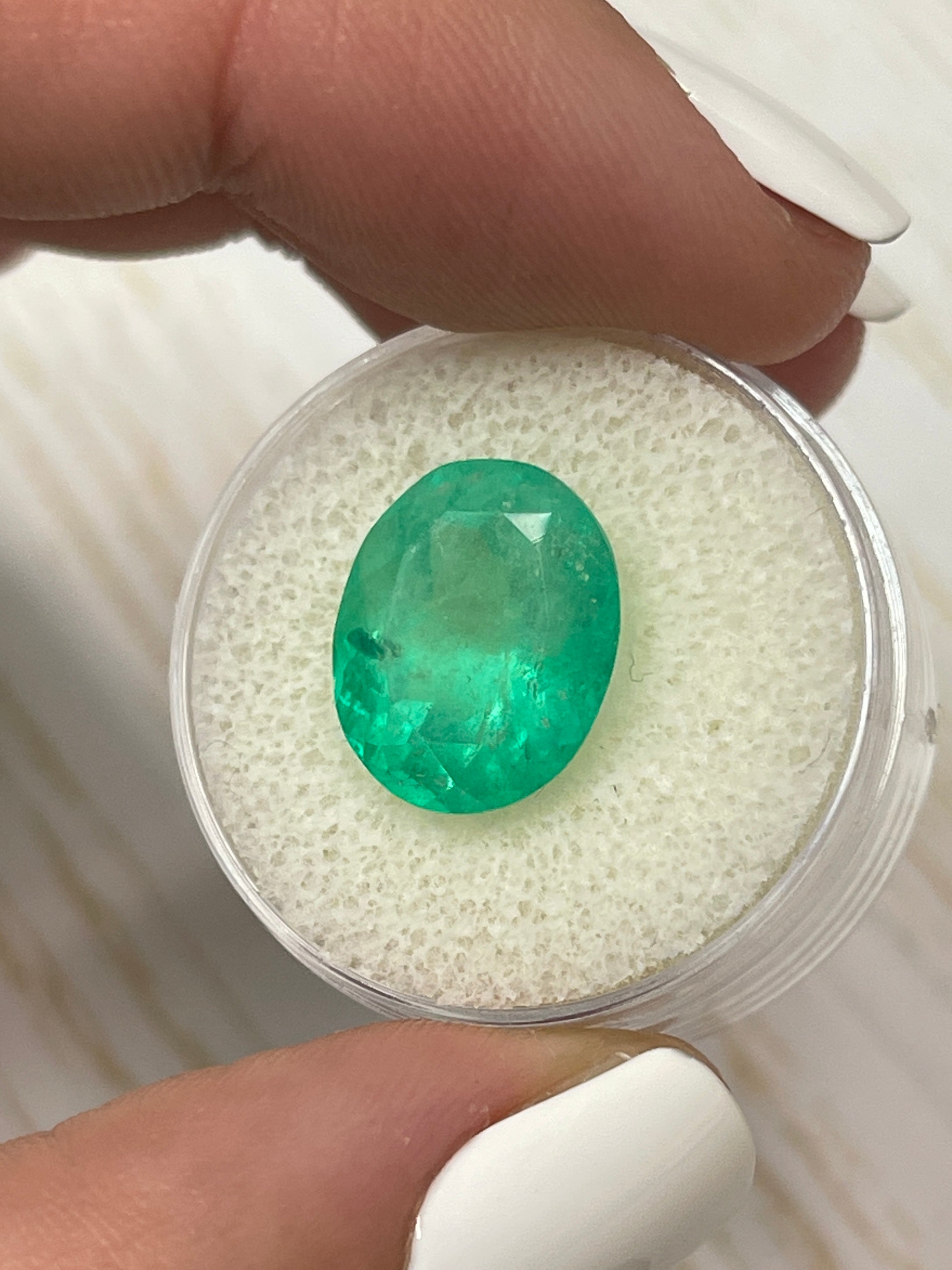 7.80 carat medium yellowish-green natural Colombian emerald loose oval cut gemstone from JR Colombian Emeralds