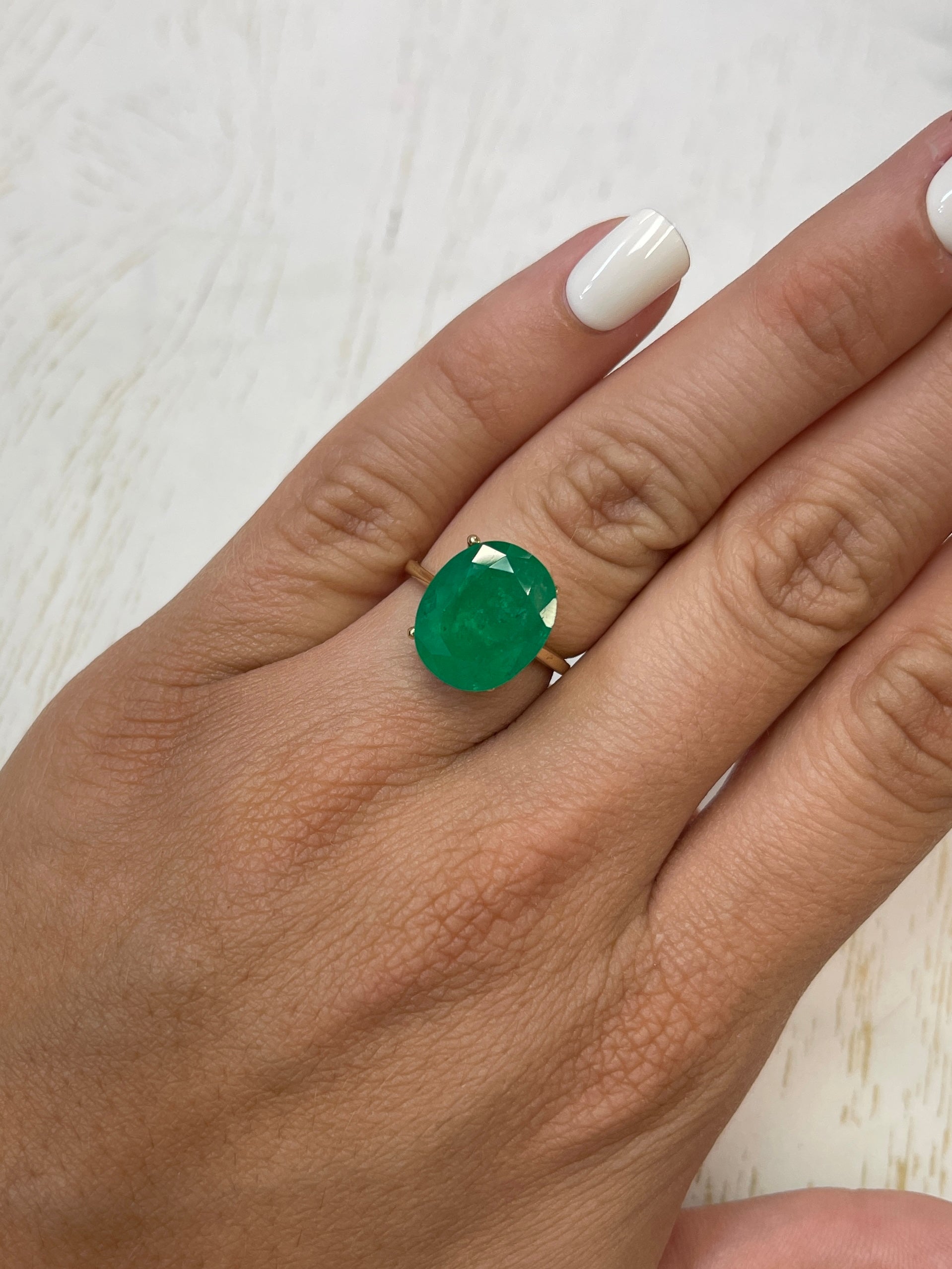 Deep green 8.29 carat natural Colombian emerald in oval cut, loose gemstone from JR Colombian Emeralds.