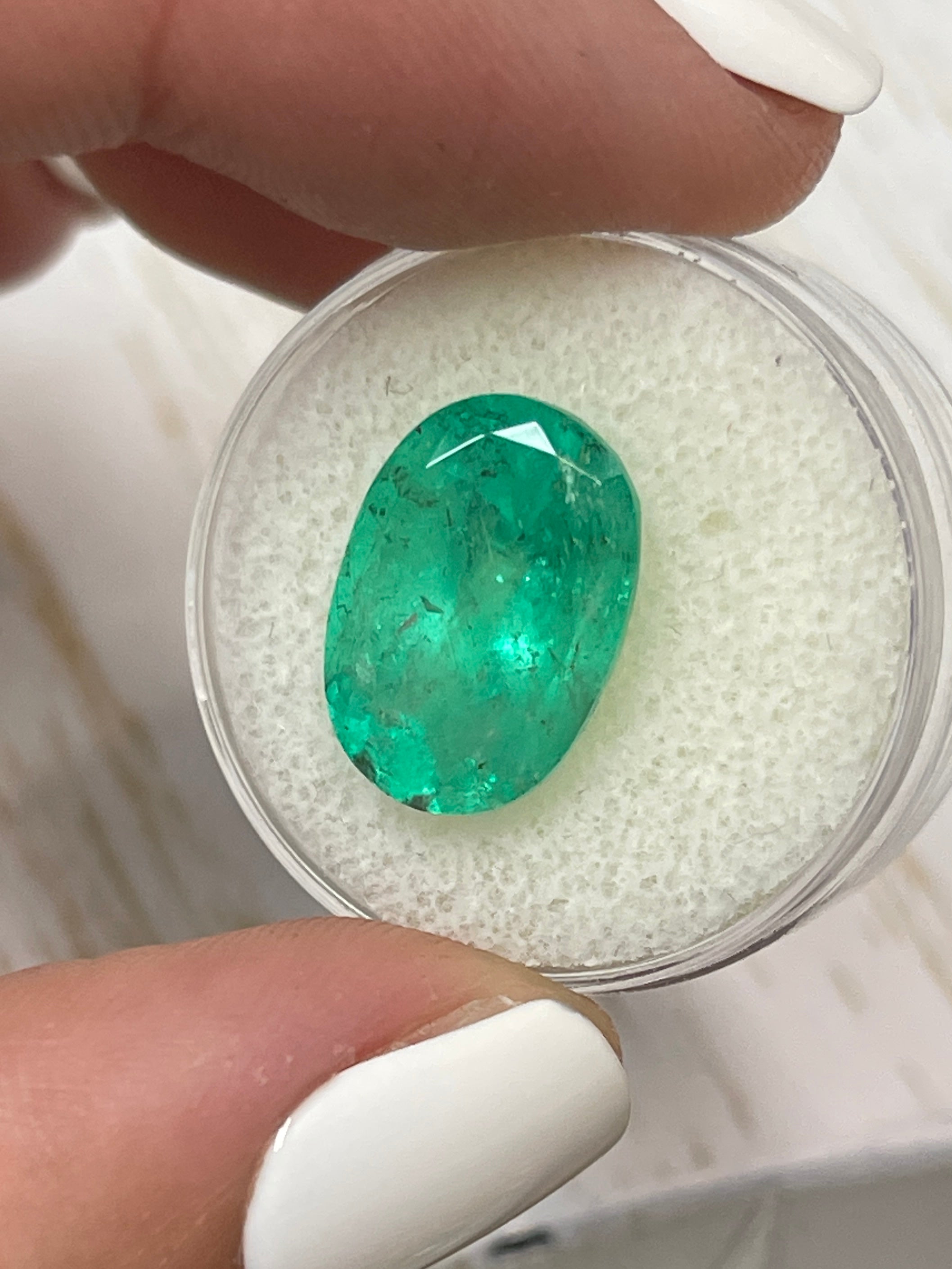 8.64 carat freckled medium green natural Colombian emerald in oval cut, loose gemstone from JR Colombian Emeralds.