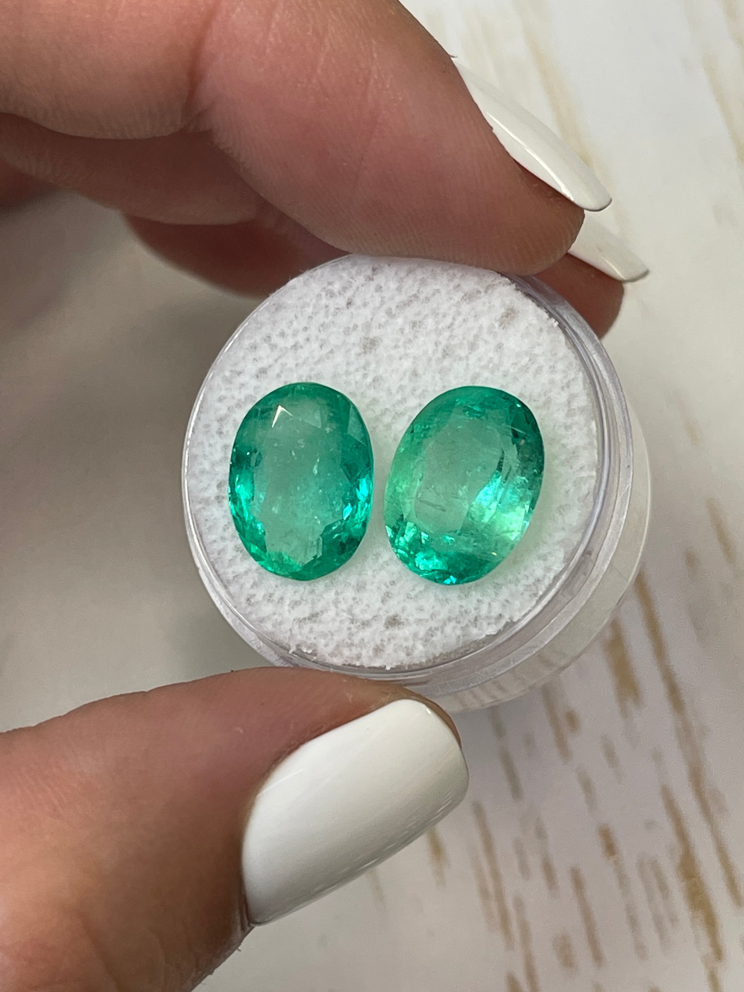 Pair of oval cut Colombian emeralds totaling 9.02 carats, matching loose gemstones with vibrant green color from JR Colombian Emeralds.