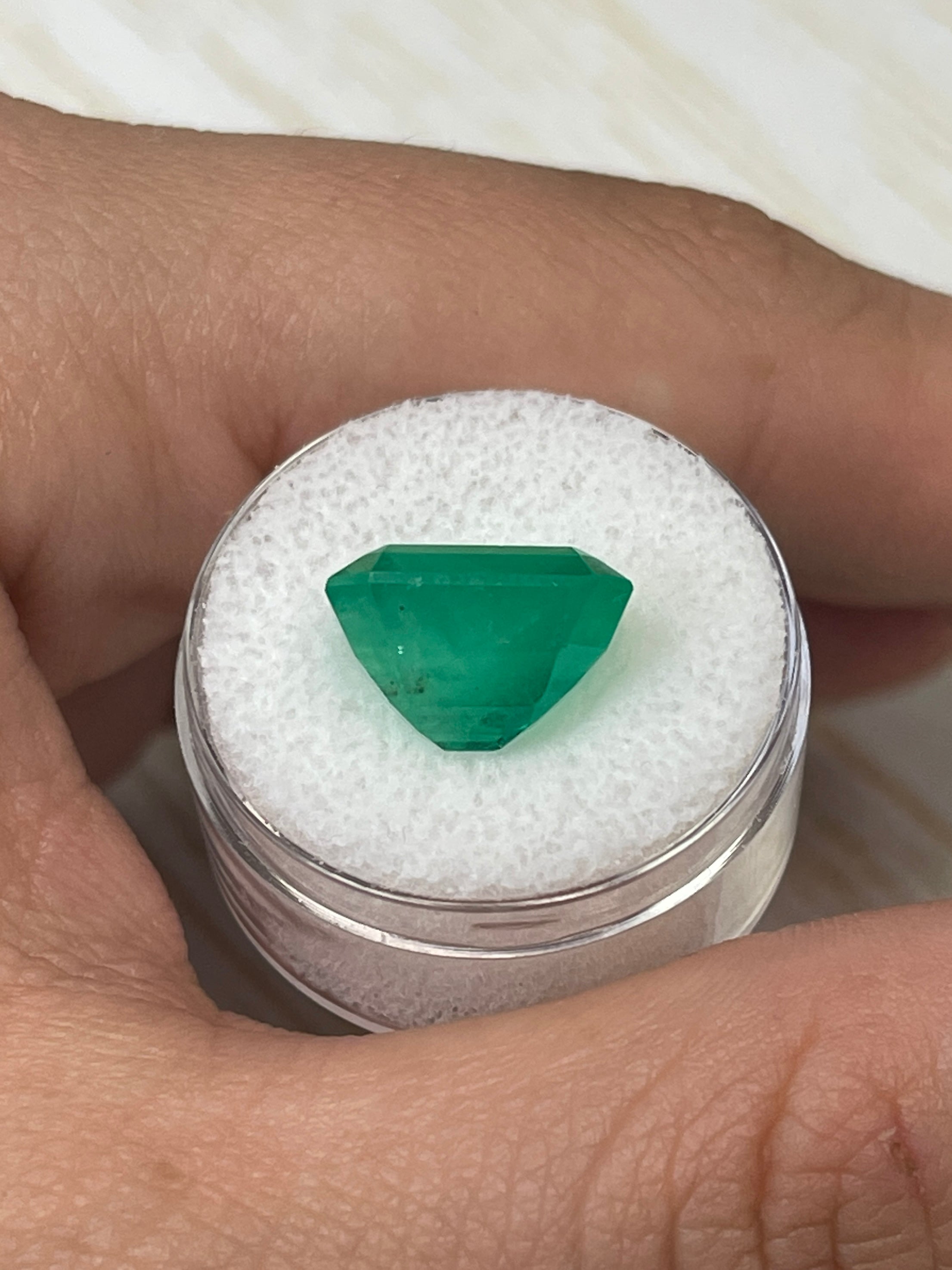 Yellowish green 9.28 carat emerald cut Colombian emerald loose gemstone from JR Colombian Emeralds.