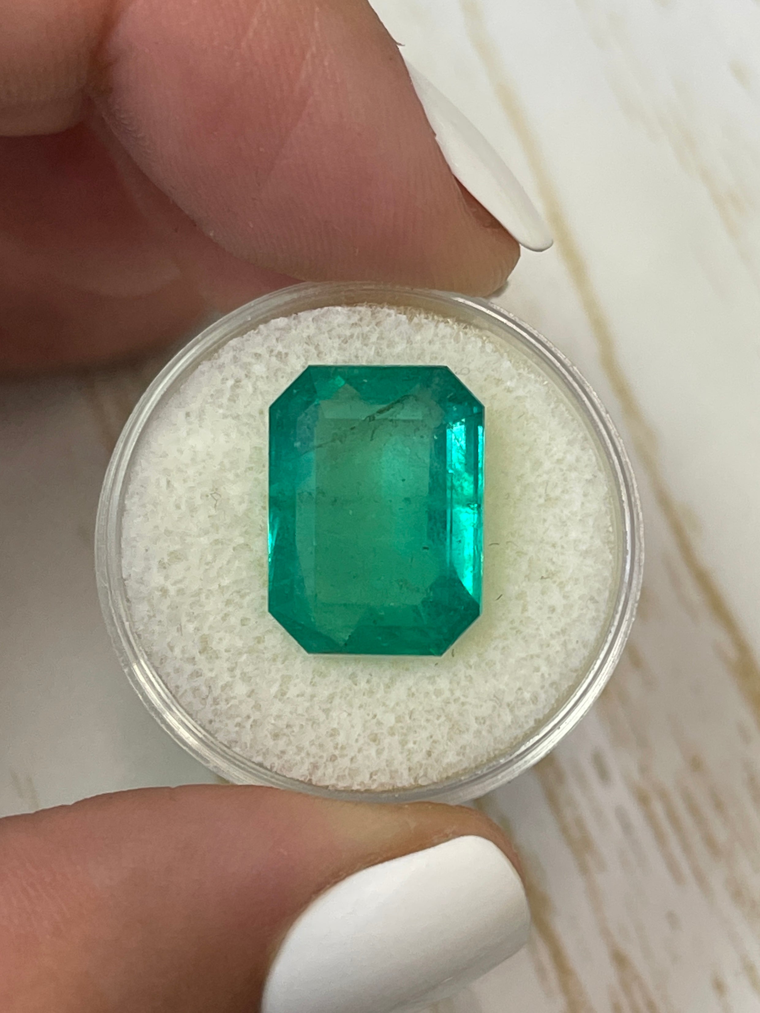 Large 9.52 carat natural Colombian emerald loose gemstone in an emerald cut, showcasing vibrant green color and clarity.