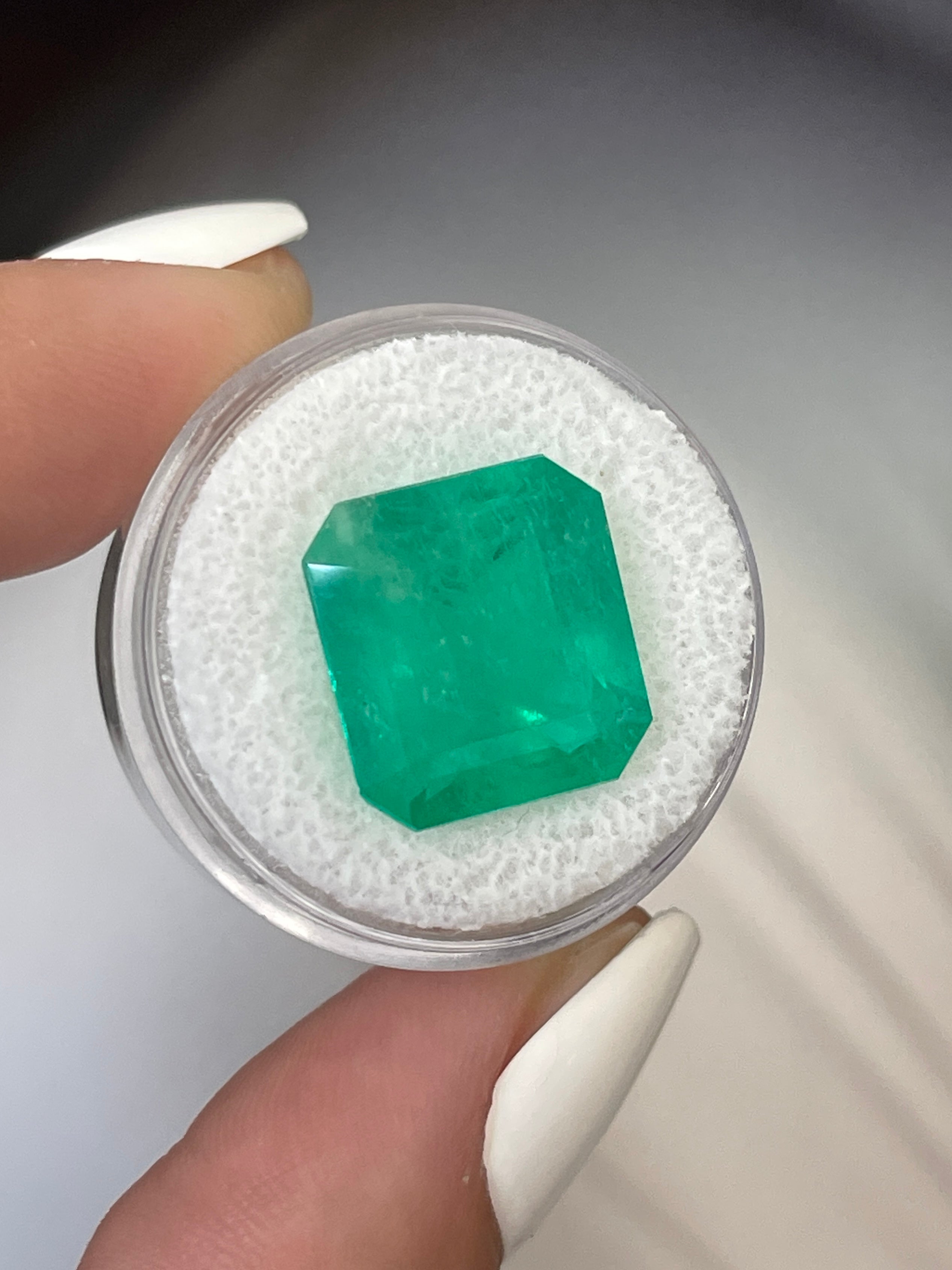 Large 12.09 carat Colombian emerald in 15x14 mm Asscher cut, showcasing vibrant green color and clarity, by JR Colombian Emeralds.