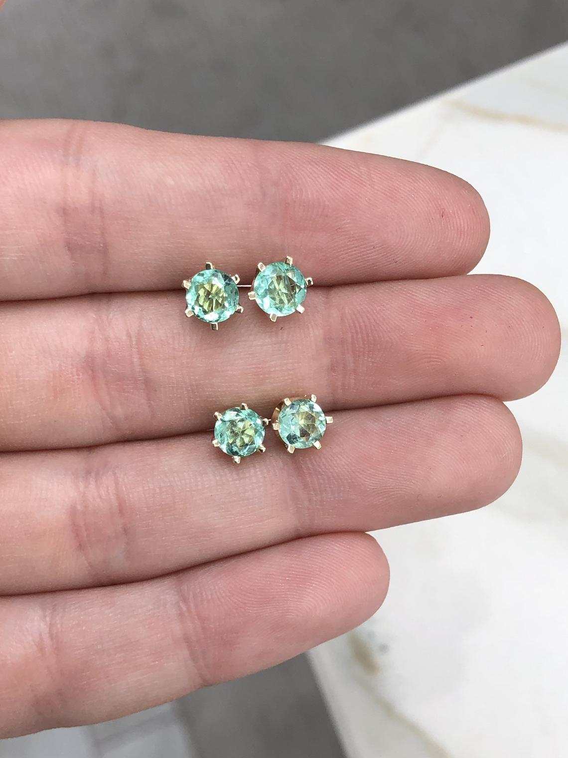 JR Colombian Emeralds 14K gold earrings with round six-prong rich bright green emeralds, totaling 1.56 carats.