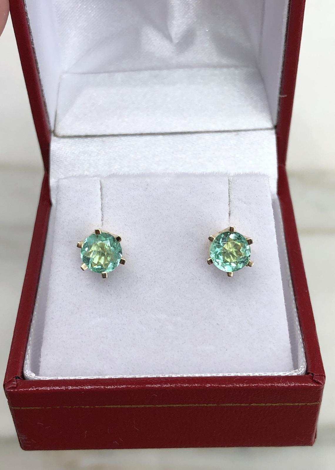 JR Colombian Emeralds 14K gold earrings with 1.56tcw round green emeralds in six-prong setting.