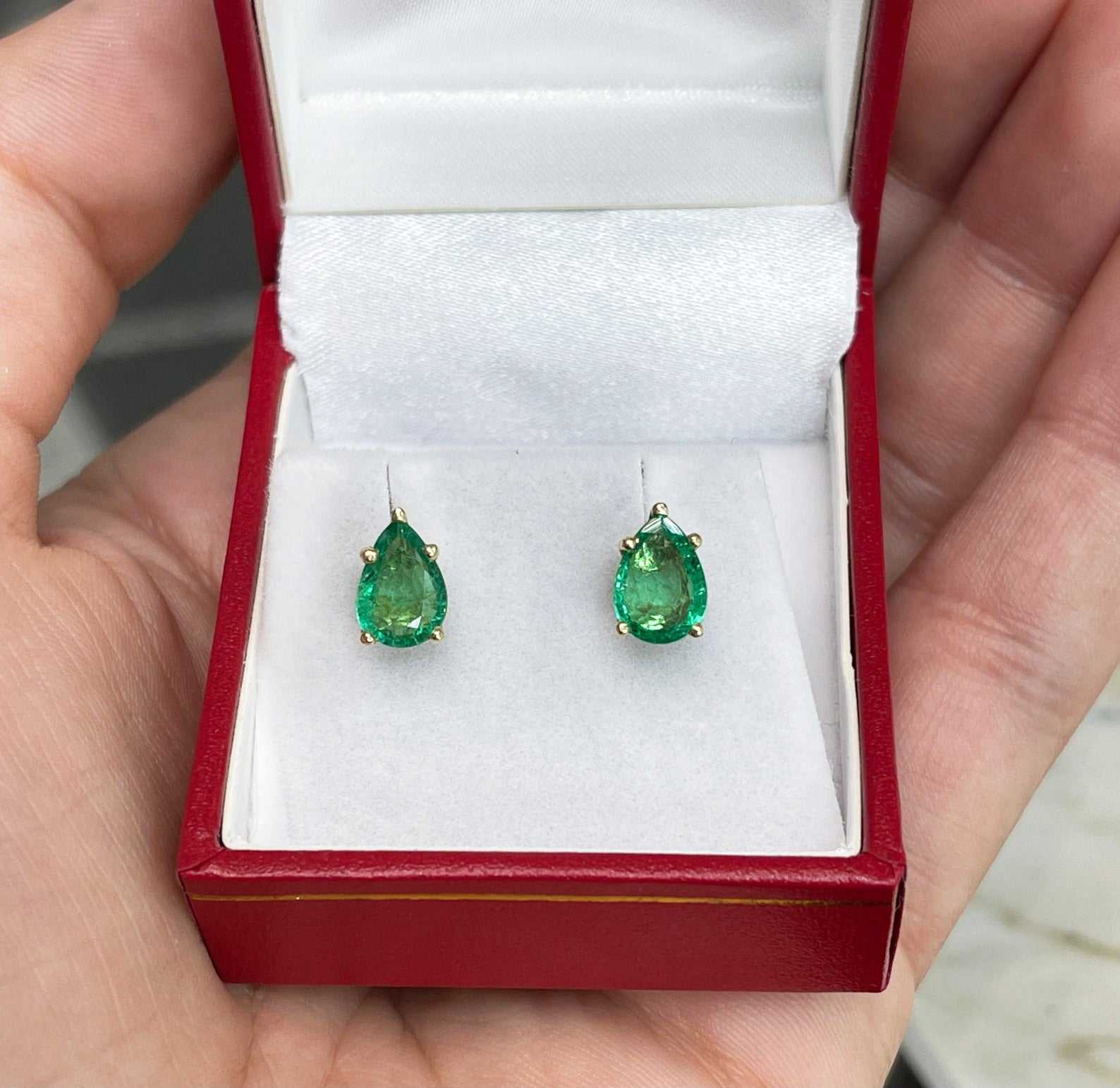 Natural pear-cut emerald stud earrings in rich green, set in 14K gold, by JR Colombian Emeralds.