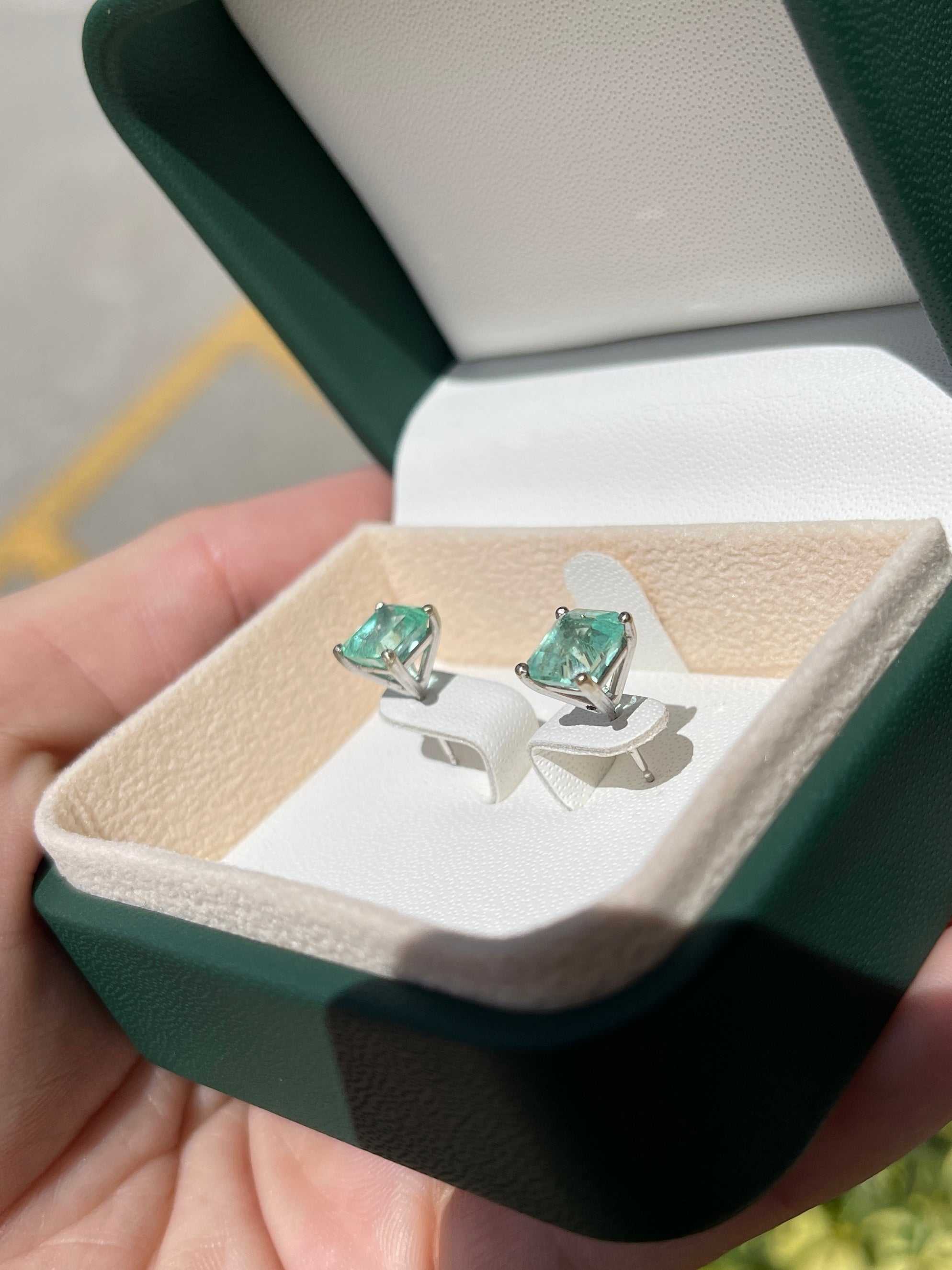 Light green Colombian emerald stud earrings in 18K white gold, featuring a martini cut design and 3.46 carats total weight.