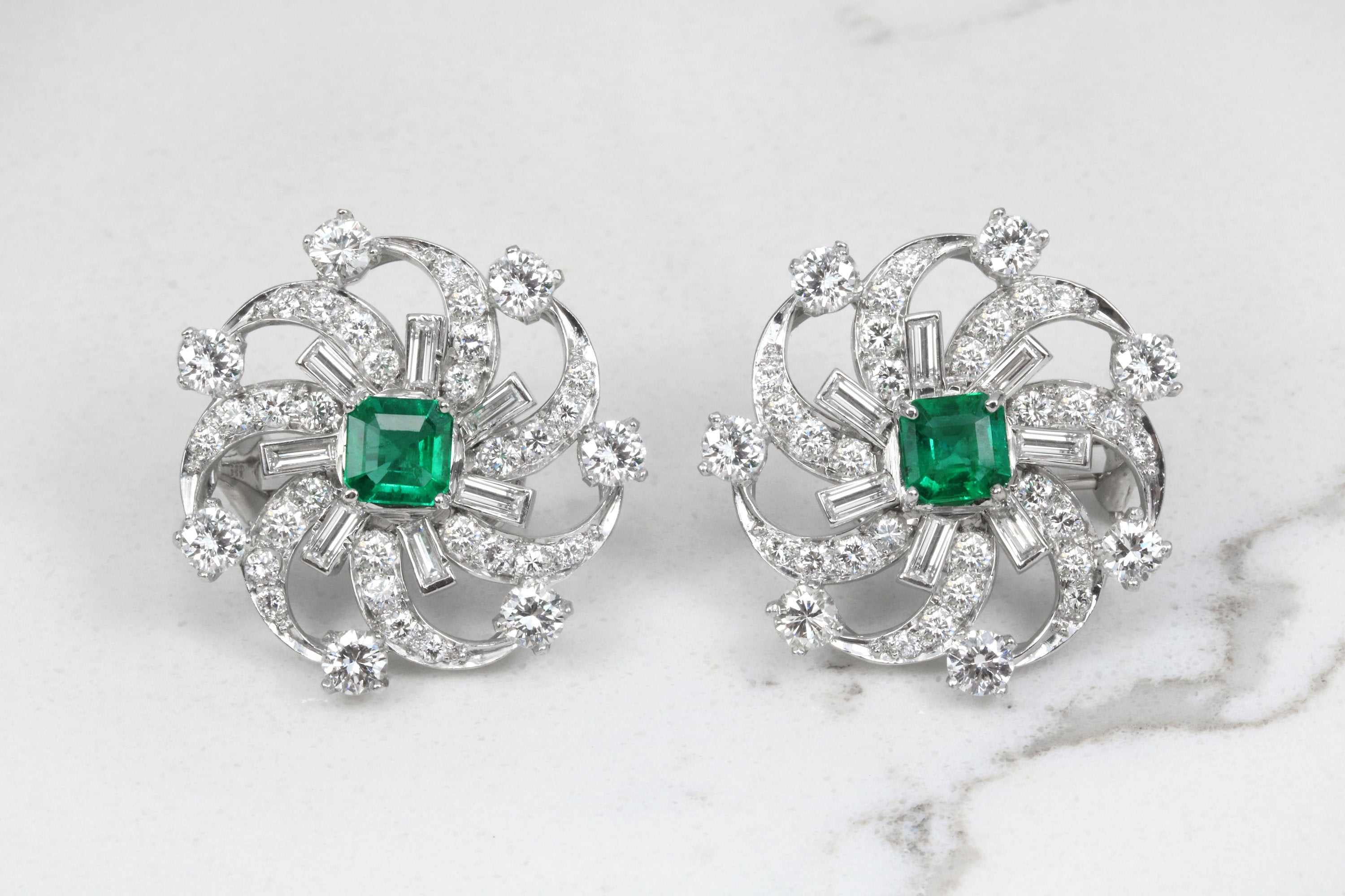 Platinum earrings with emerald and diamond spiral design, featuring fine quality 6.70tcw gemstones by JR Colombian Emeralds.