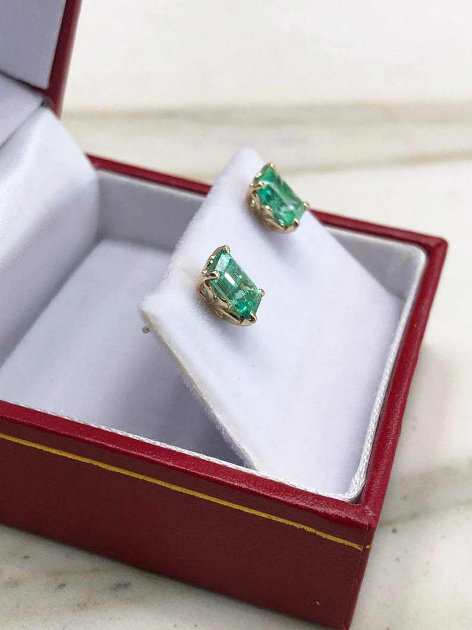Trendy fleur de lis emerald cut Colombian emerald stud earrings in 14K gold with 1.50tcw for women.