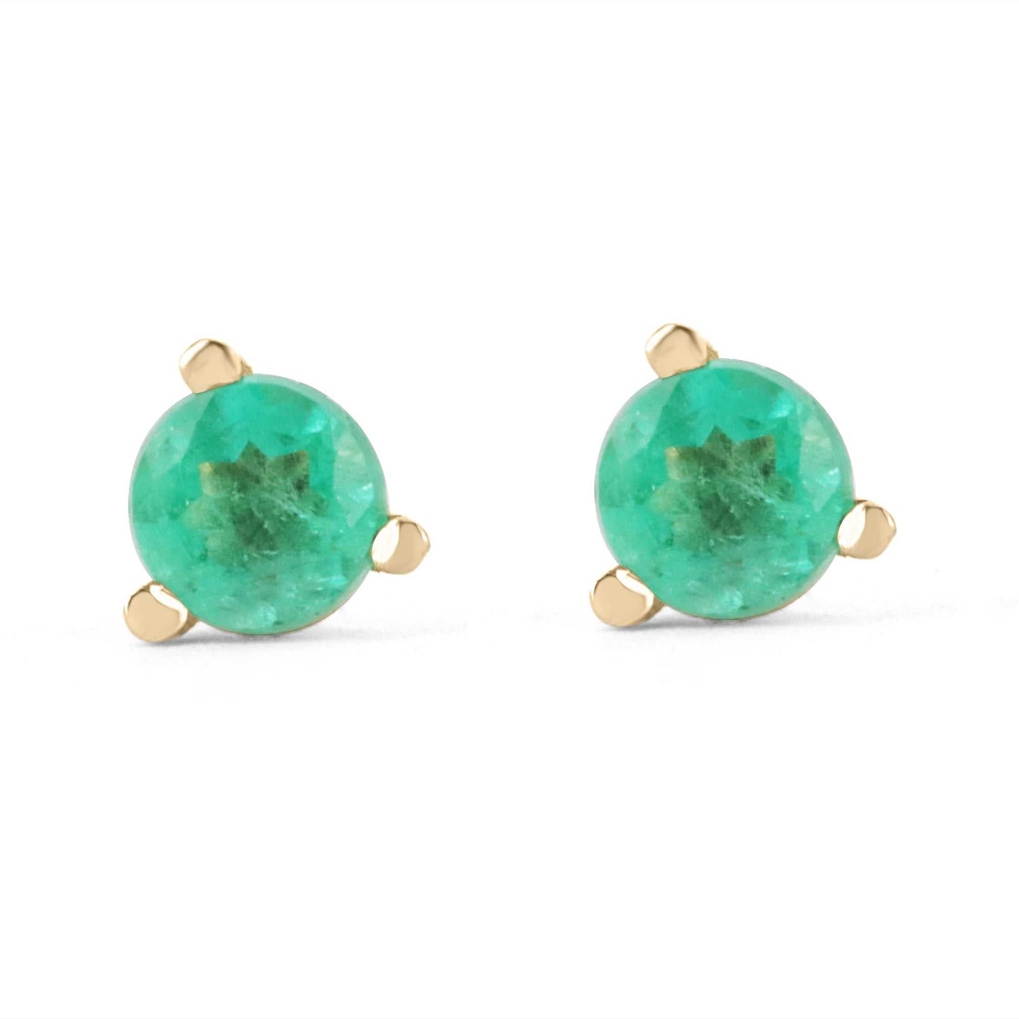 Dainty rich green emerald round cut baby stud earrings set in 14K yellow gold with three-prong martini setting