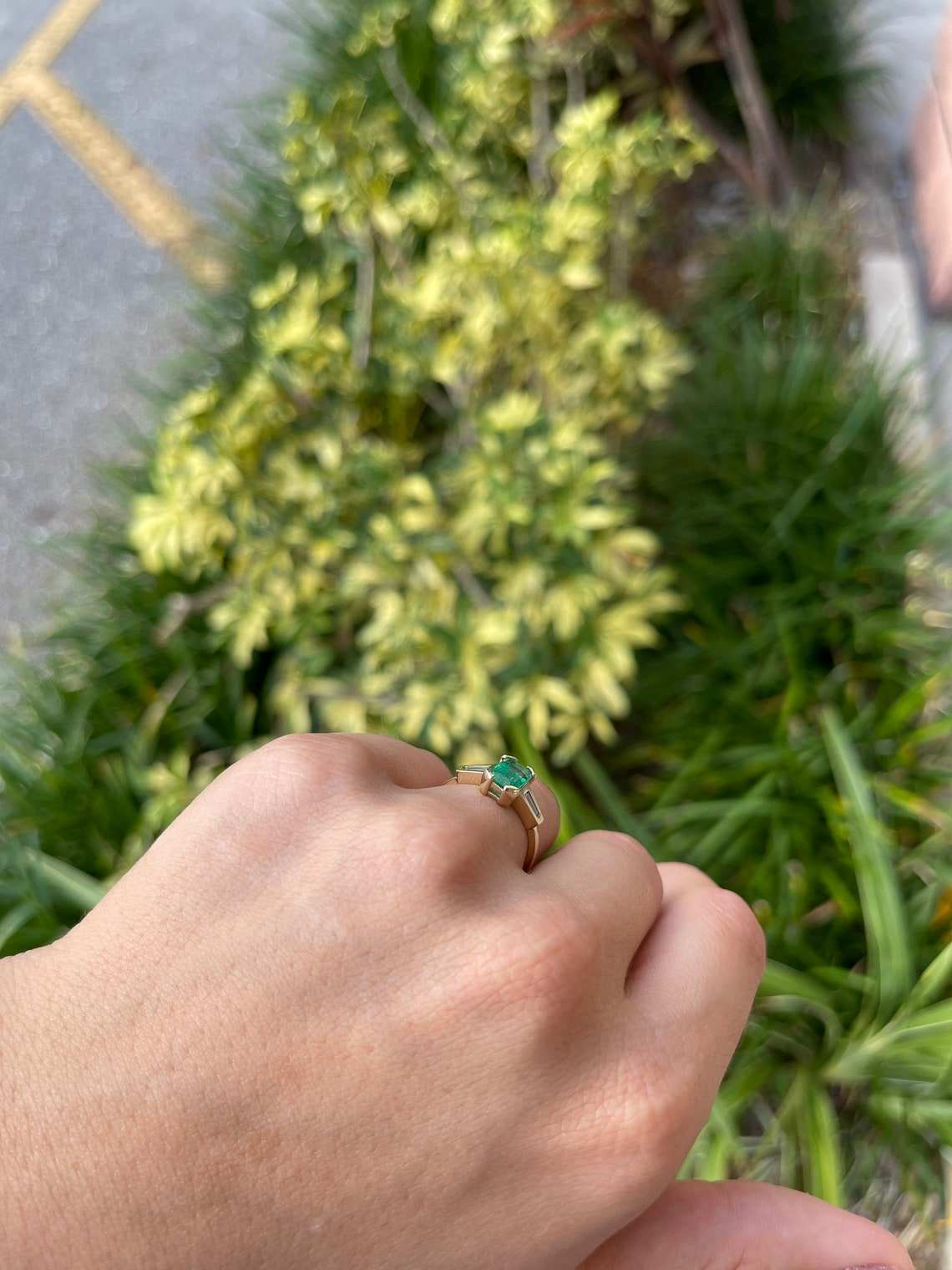 Ladies emerald ring featuring a 2.15tcw Colombian emerald cut emerald with tapered baguette diamonds in 14K gold.