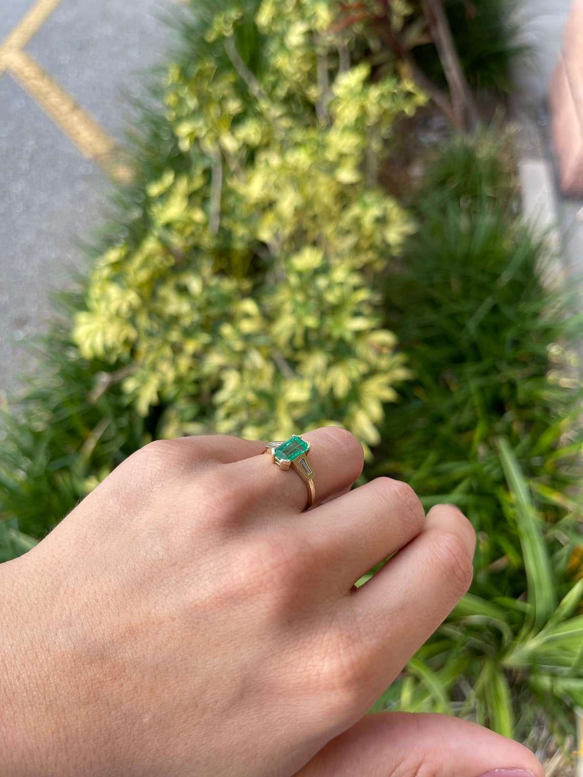 Ladies emerald ring featuring a 2.15tcw emerald cut Colombian emerald and tapered baguette diamonds in 14K gold.