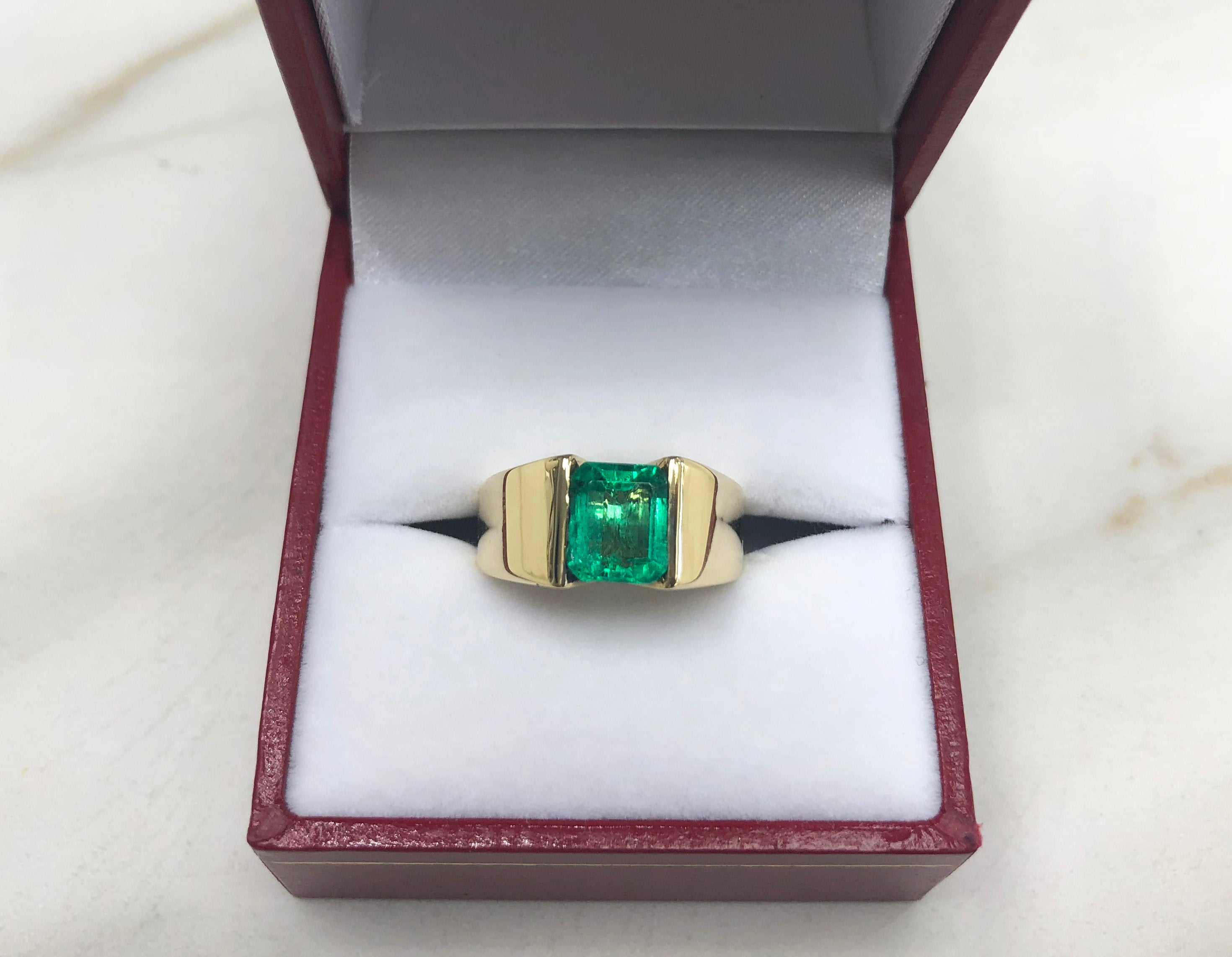 Men's 14K yellow gold ring with a 2.0 carat emerald cut vivid green solitaire emerald by JR Colombian Emeralds.