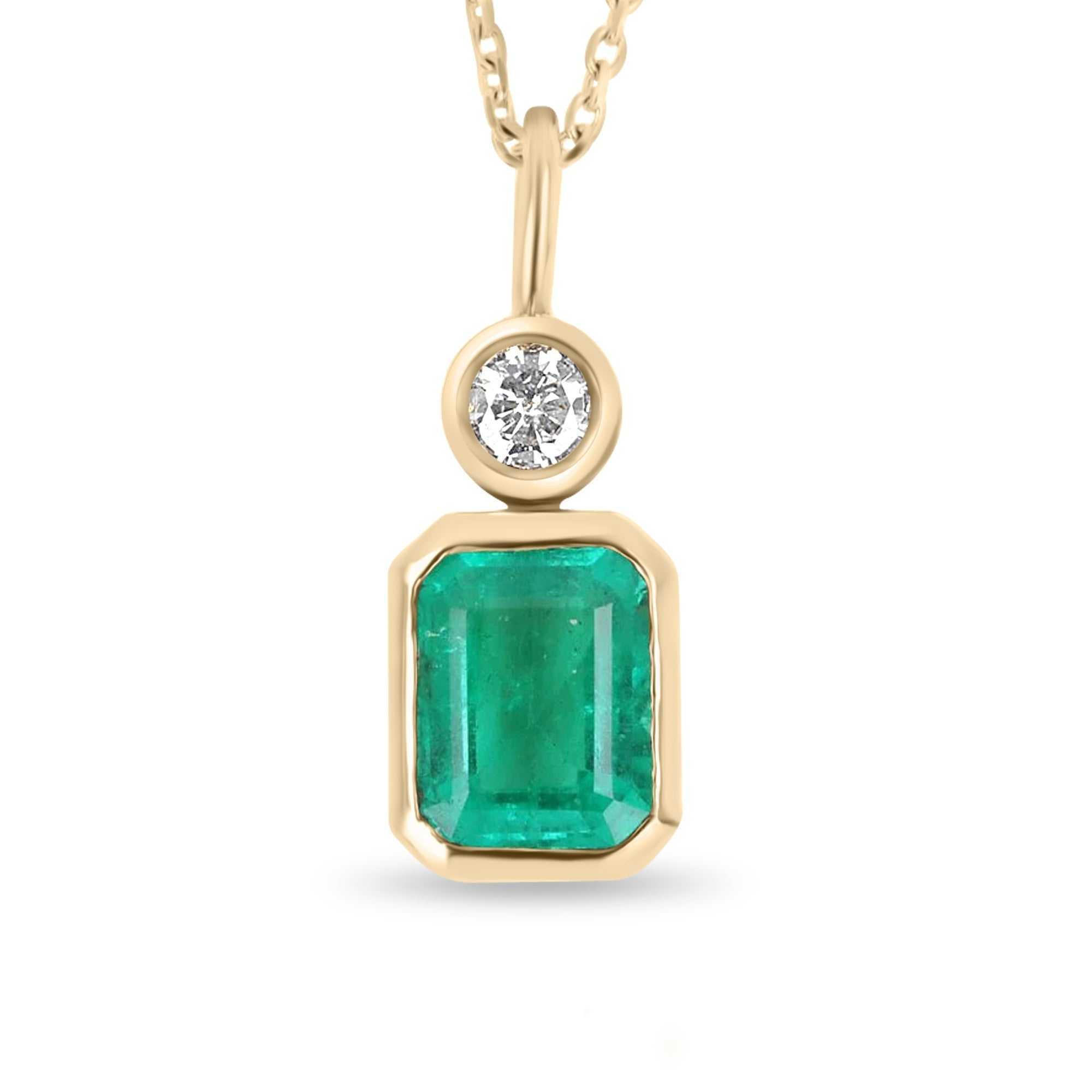 14K yellow gold pendant with 1.41ct emerald cut Zambian emerald and 0.17ct round diamond bezel set
