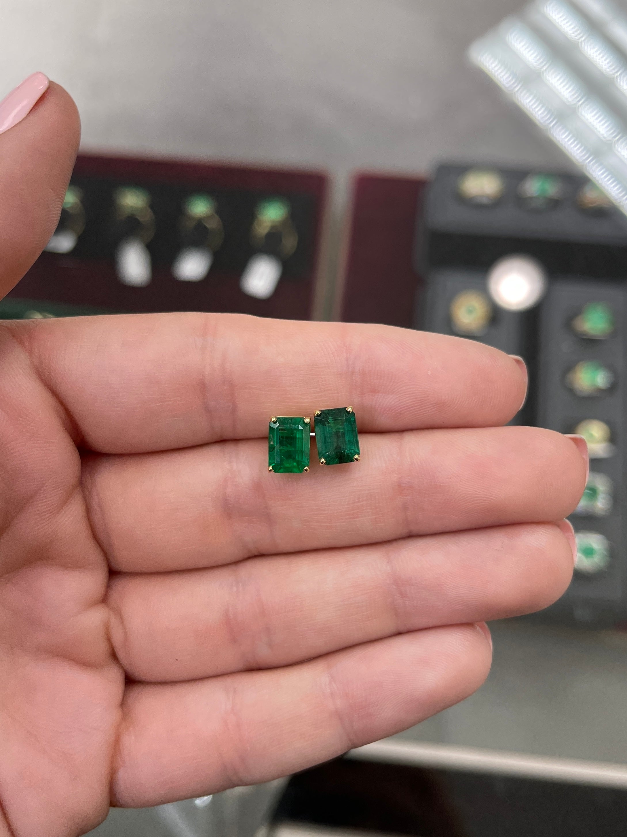 Vivid dark forest green AAA emerald cut stud earrings in 18K gold by JR Colombian Emeralds, showcasing a bold statement design.