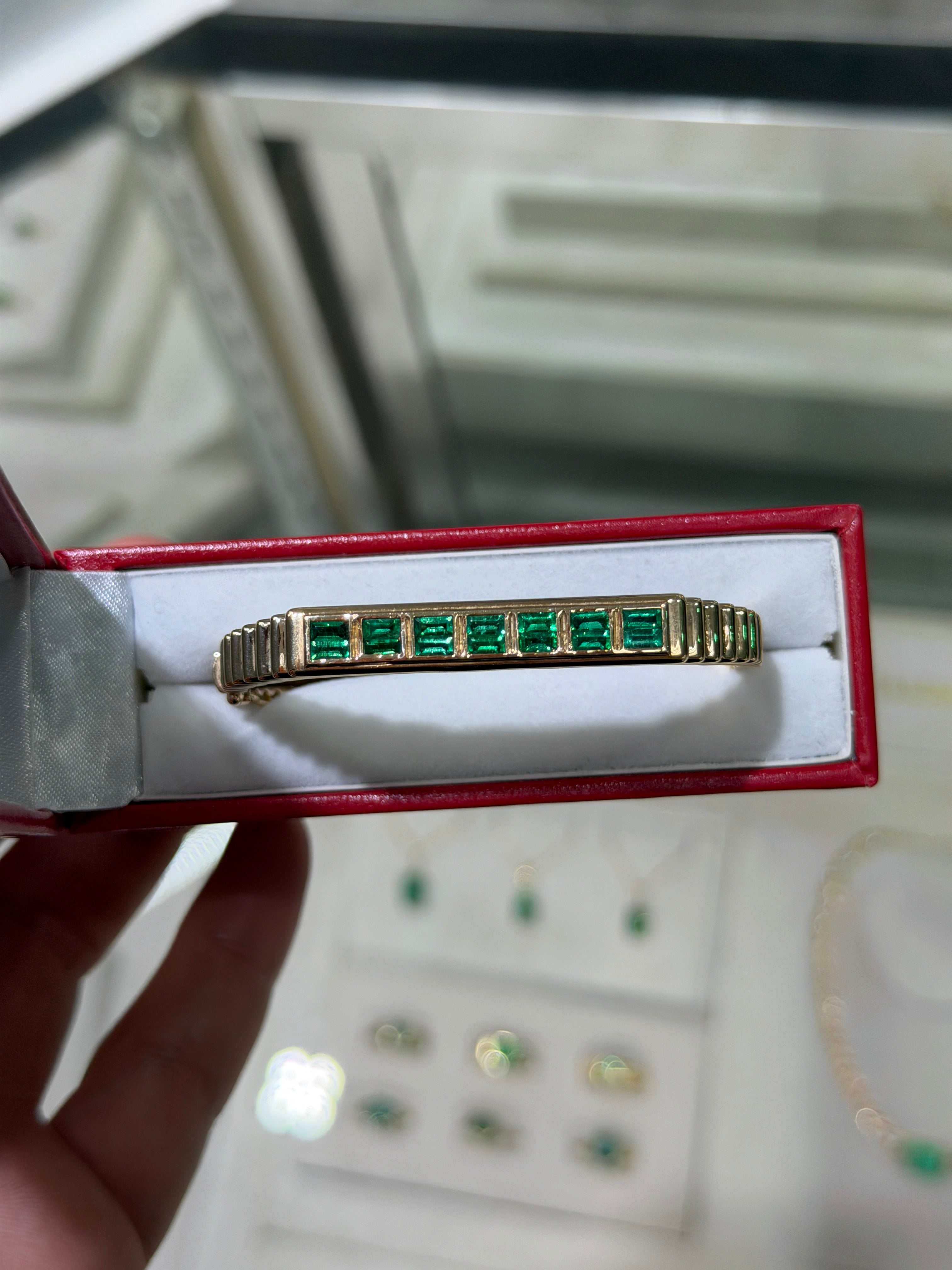 14K gold bangle bracelet with 1.64tcw princess cut emeralds, bezel set in a ribbed design by JR Colombian Emeralds.