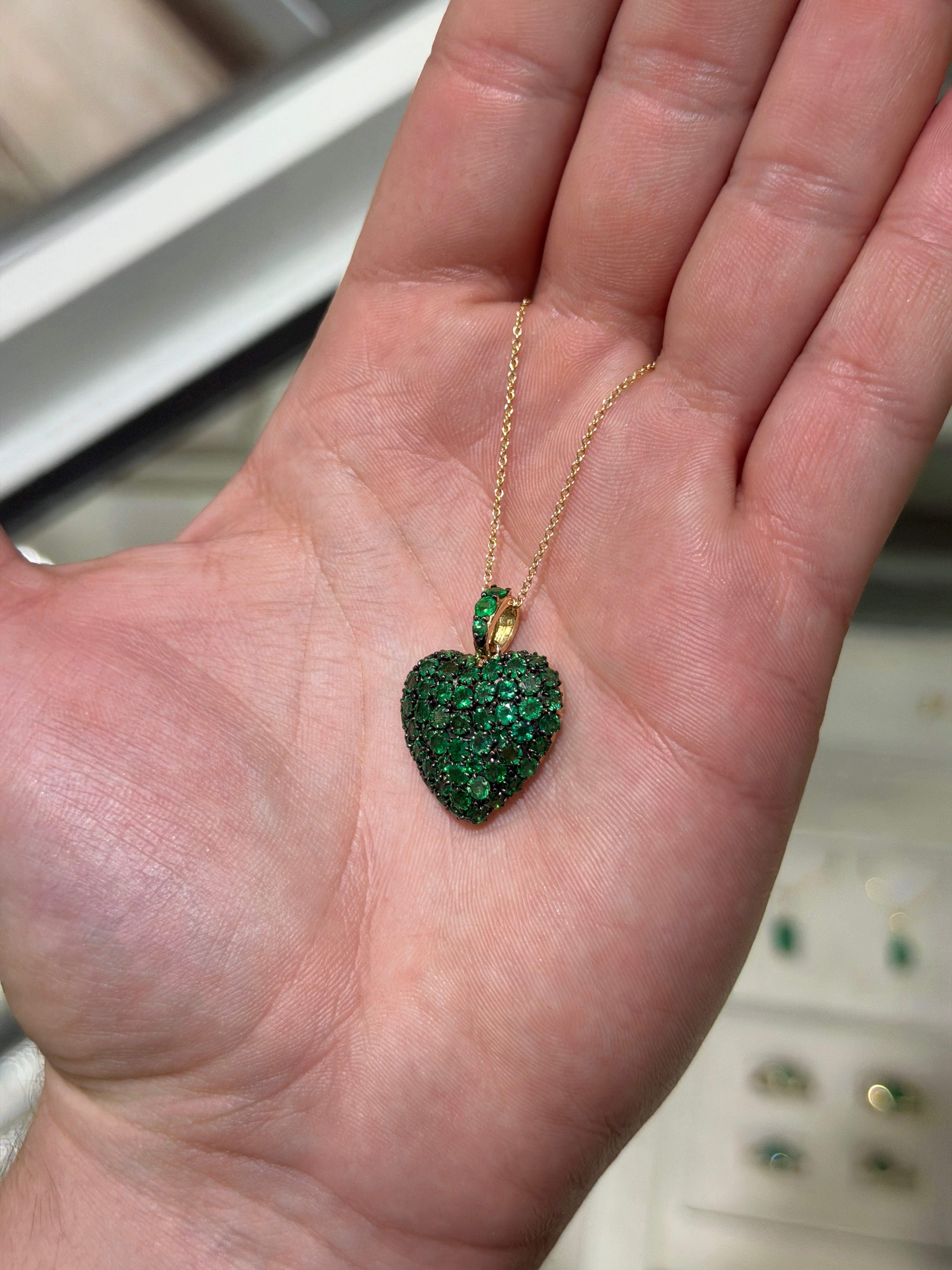14K gold emerald cluster heart pendant with black rhodium by JR Colombian Emeralds featuring a 4.73tcw emeralds and multi-prong setting.
