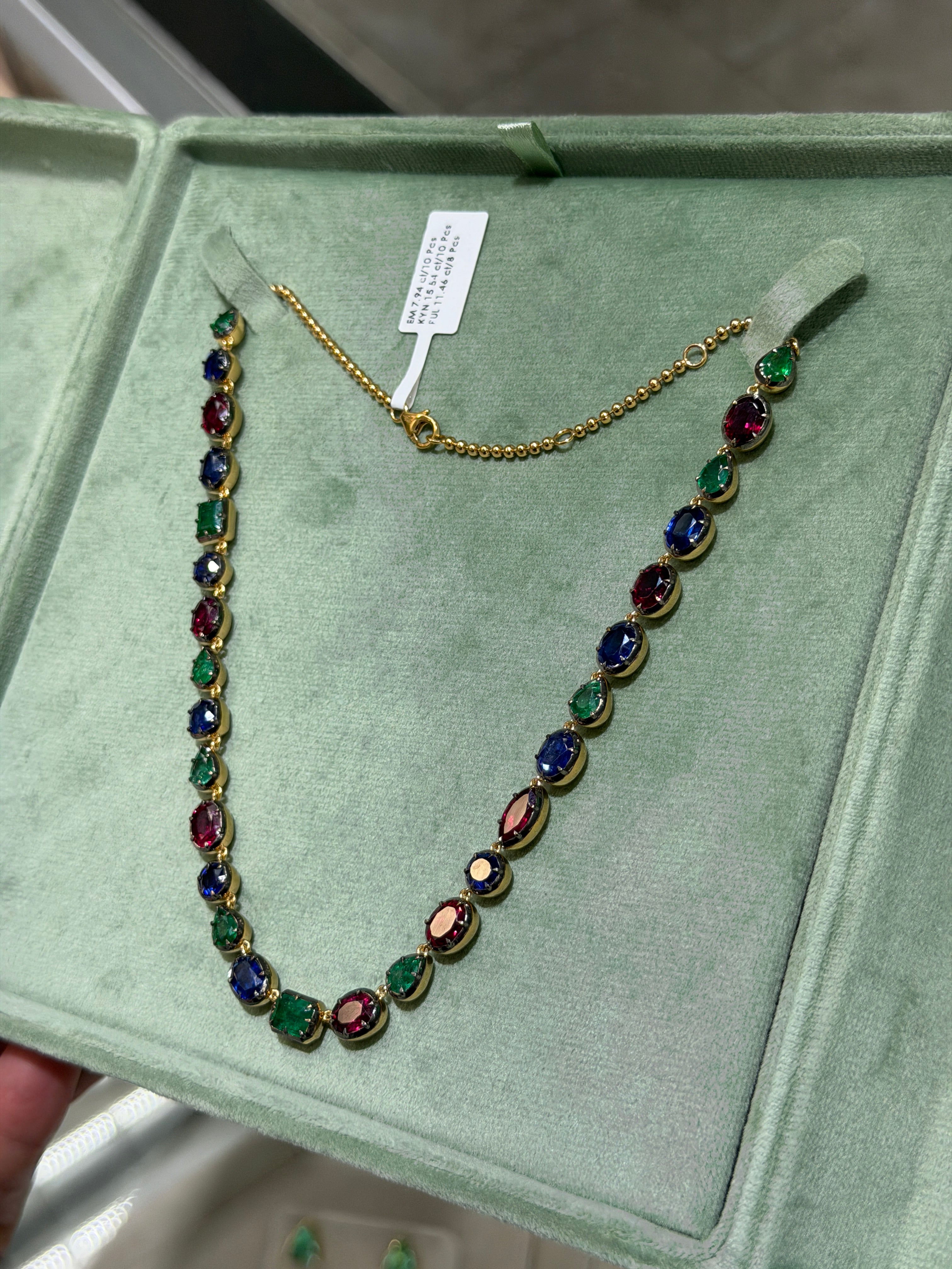 Natural emerald, ruby, and kyanite mixed color 17-inch 925 silver necklace by JR Colombian Emeralds with a detailed cut design.