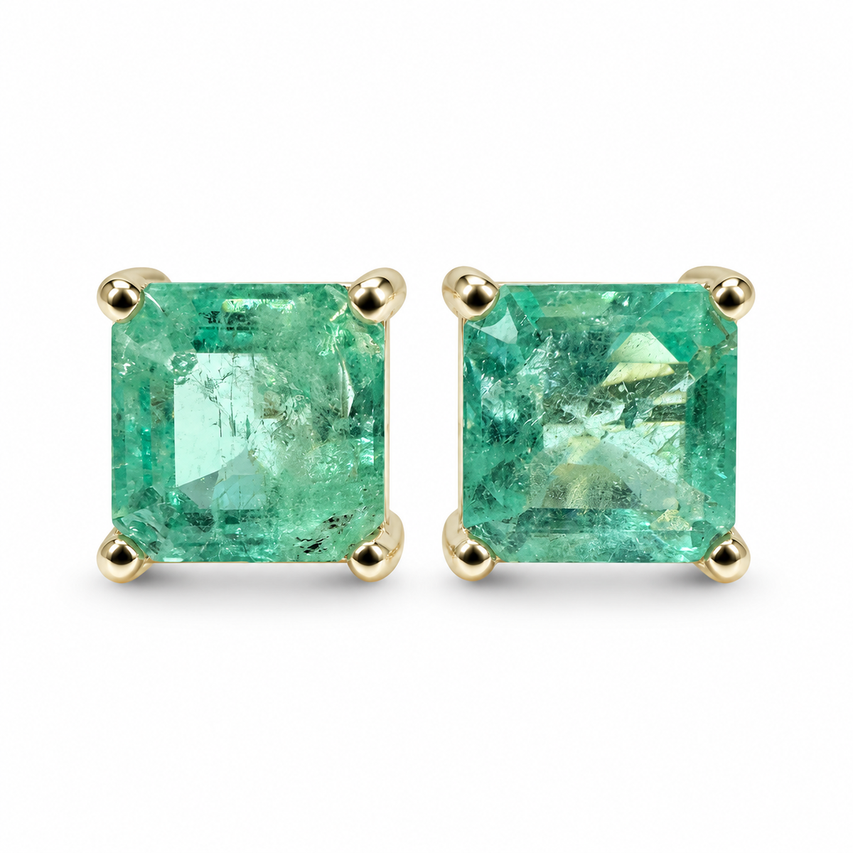 Asscher cut Colombian emerald stud earrings featuring 3.97tcw of earthy-spring green emeralds in 14K setting.