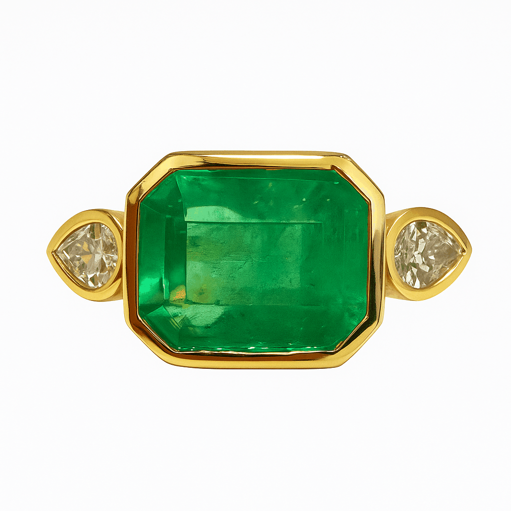 East to West Colombian Emerald ring with pear diamond three stone set in 18K yellow gold