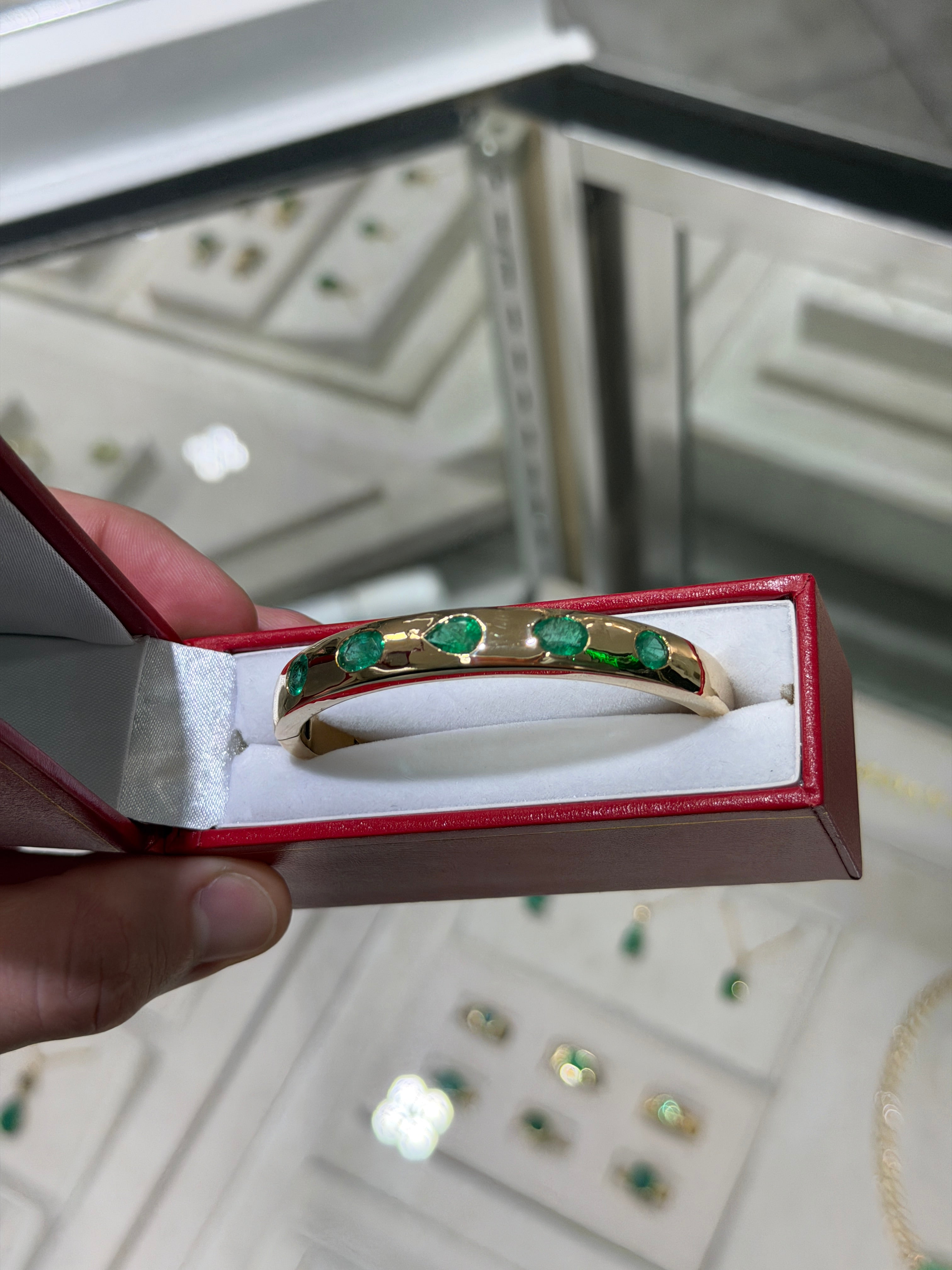 Green pear and oval cut emerald bangle bracelet with 5.66 tcw in 14K gold bezel setting by JR Colombian Emeralds.