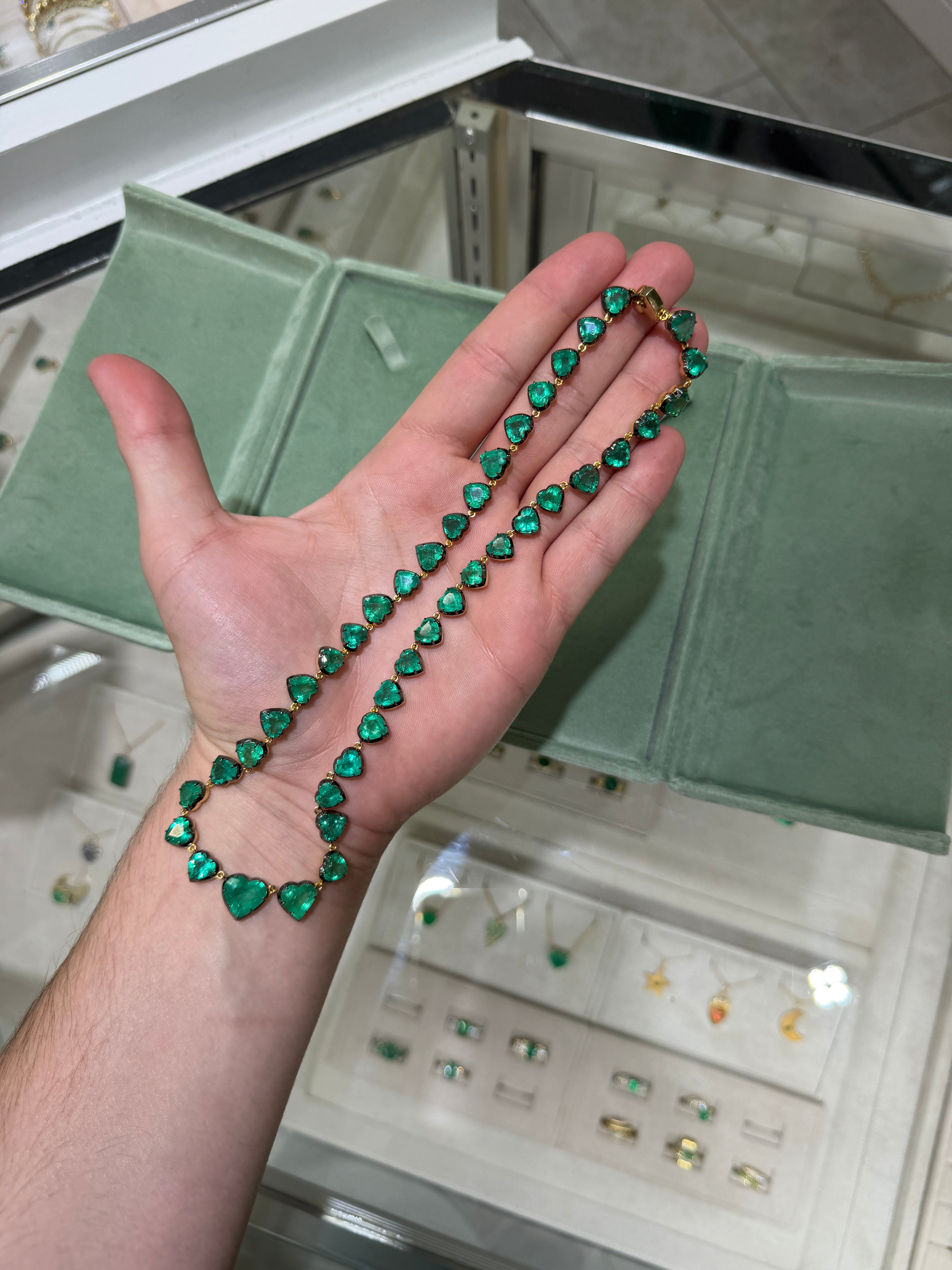 14K gold custom cut heart emerald tennis necklace with black rhodium, 60.98 carats, 18-inch length, by JR Colombian Emeralds.