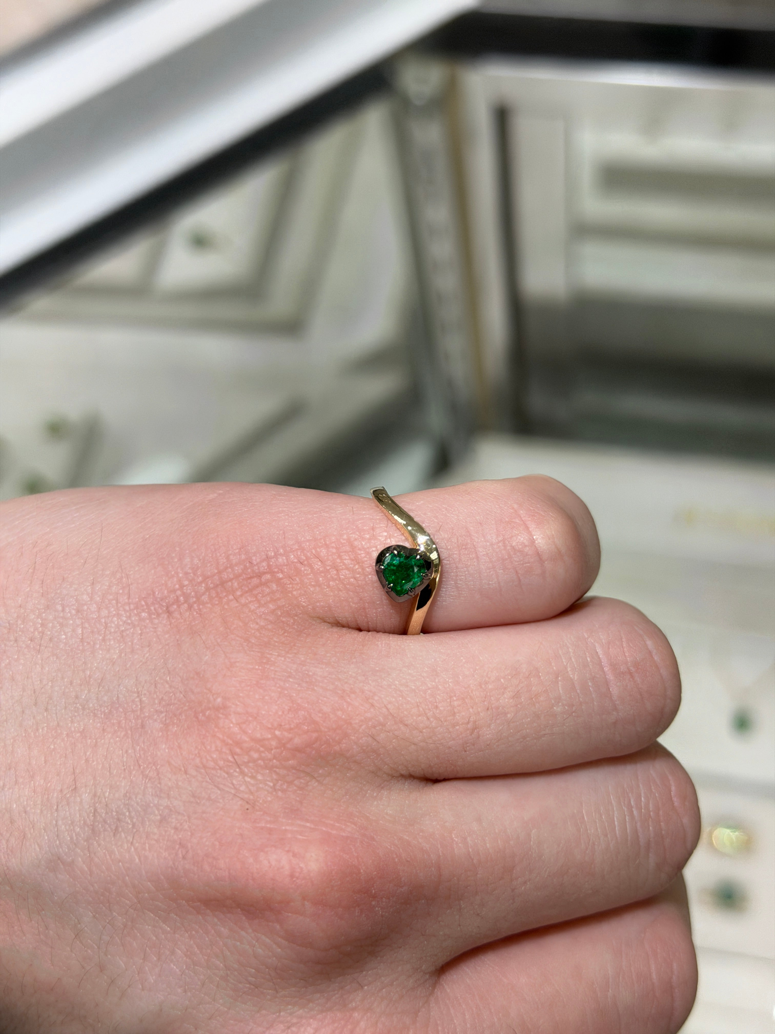14K gold heart-cut emerald solitaire ring with black rhodium by JR Colombian Emeralds, featuring a 0.53ct center stone and multi-prong setting.