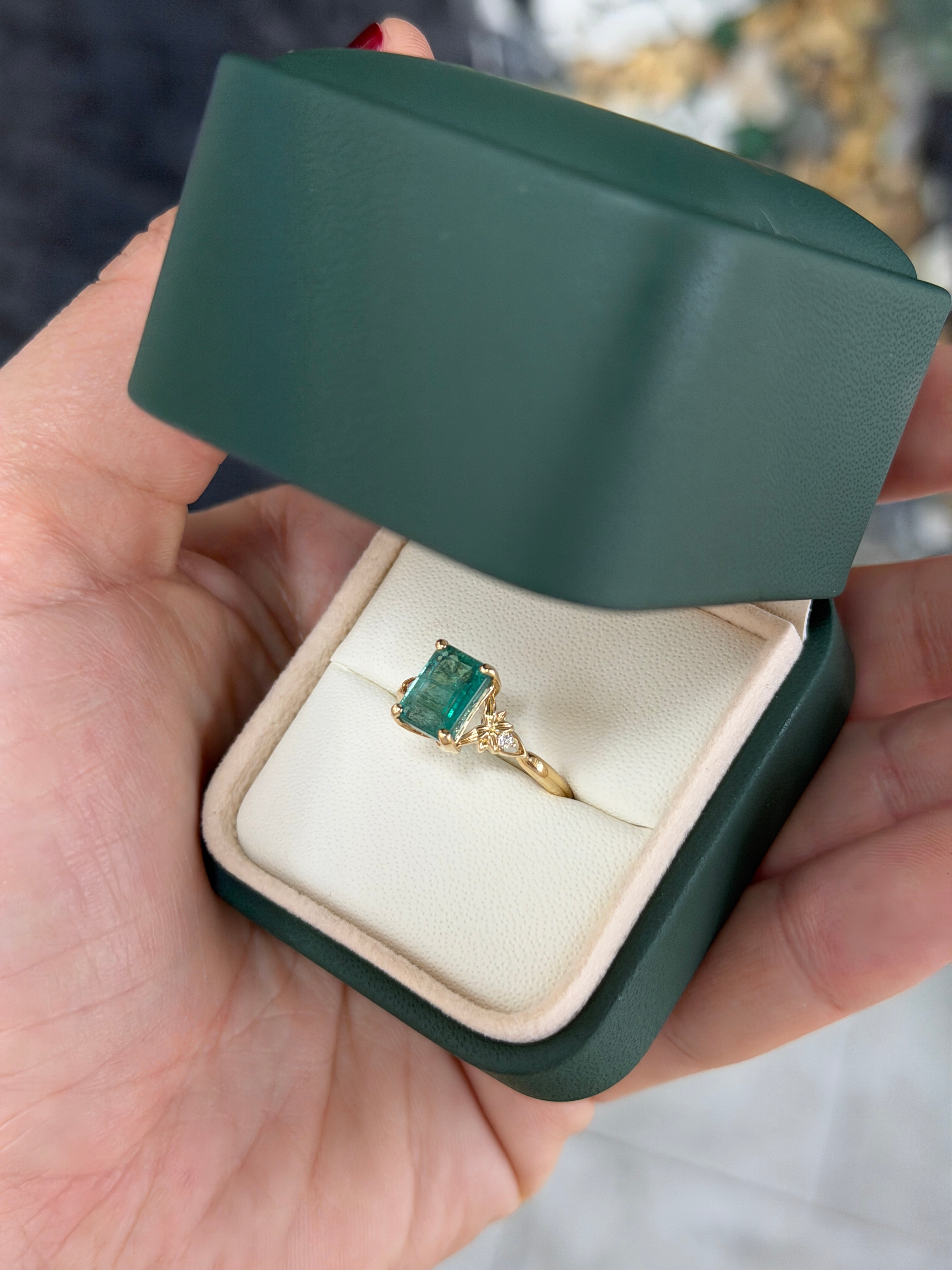 Anello solitario in oro 14 carati con smeraldo, impreziosito da diamanti sintetici per un totale di 2,30 carati, caratterizzato da una gemma centrale di smeraldo e da un design elegante.