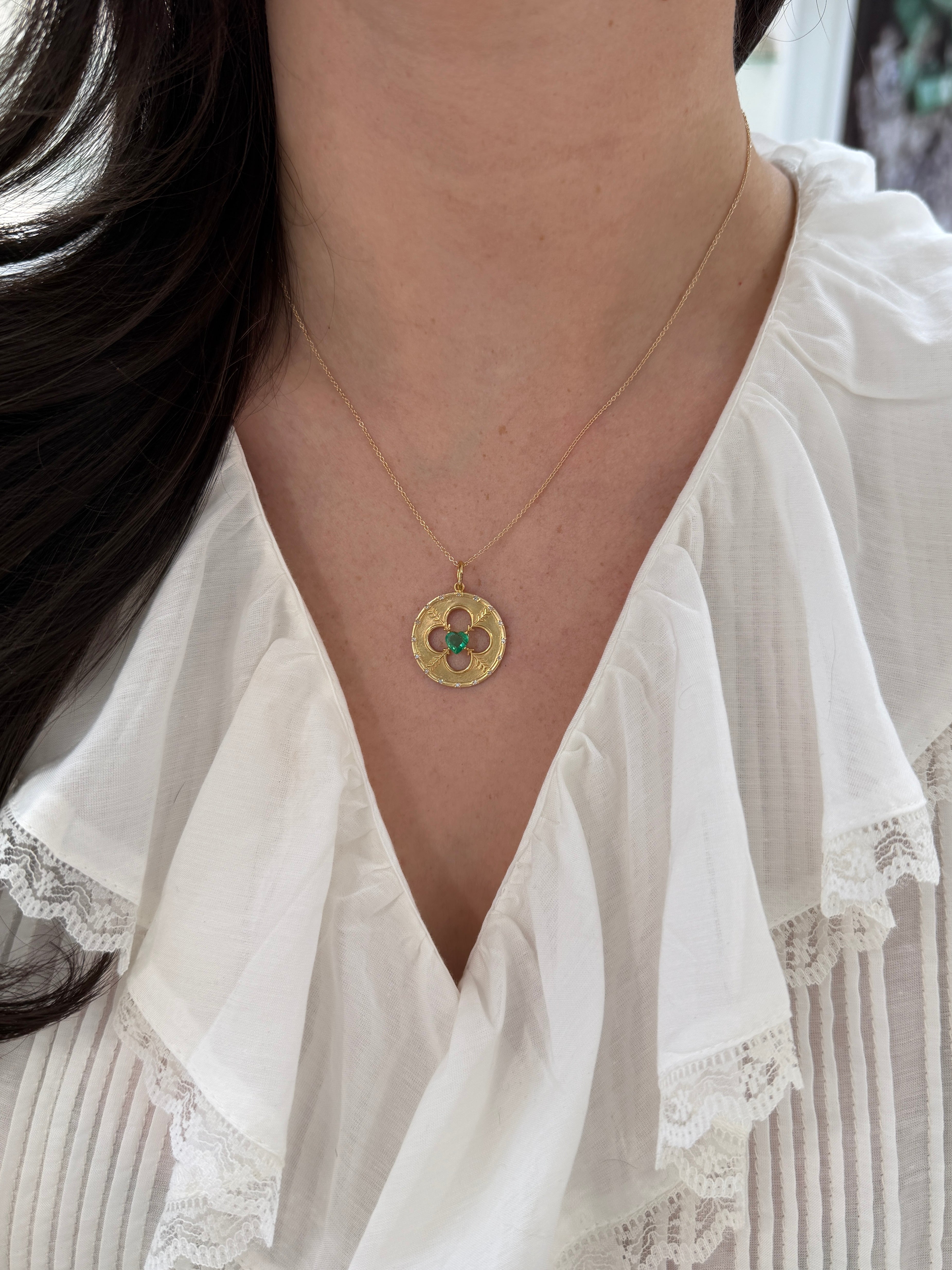 14K gold heart-shaped emerald and diamond medallion pendant with 0.86tcw from JR Colombian Emeralds, featuring intricate design.