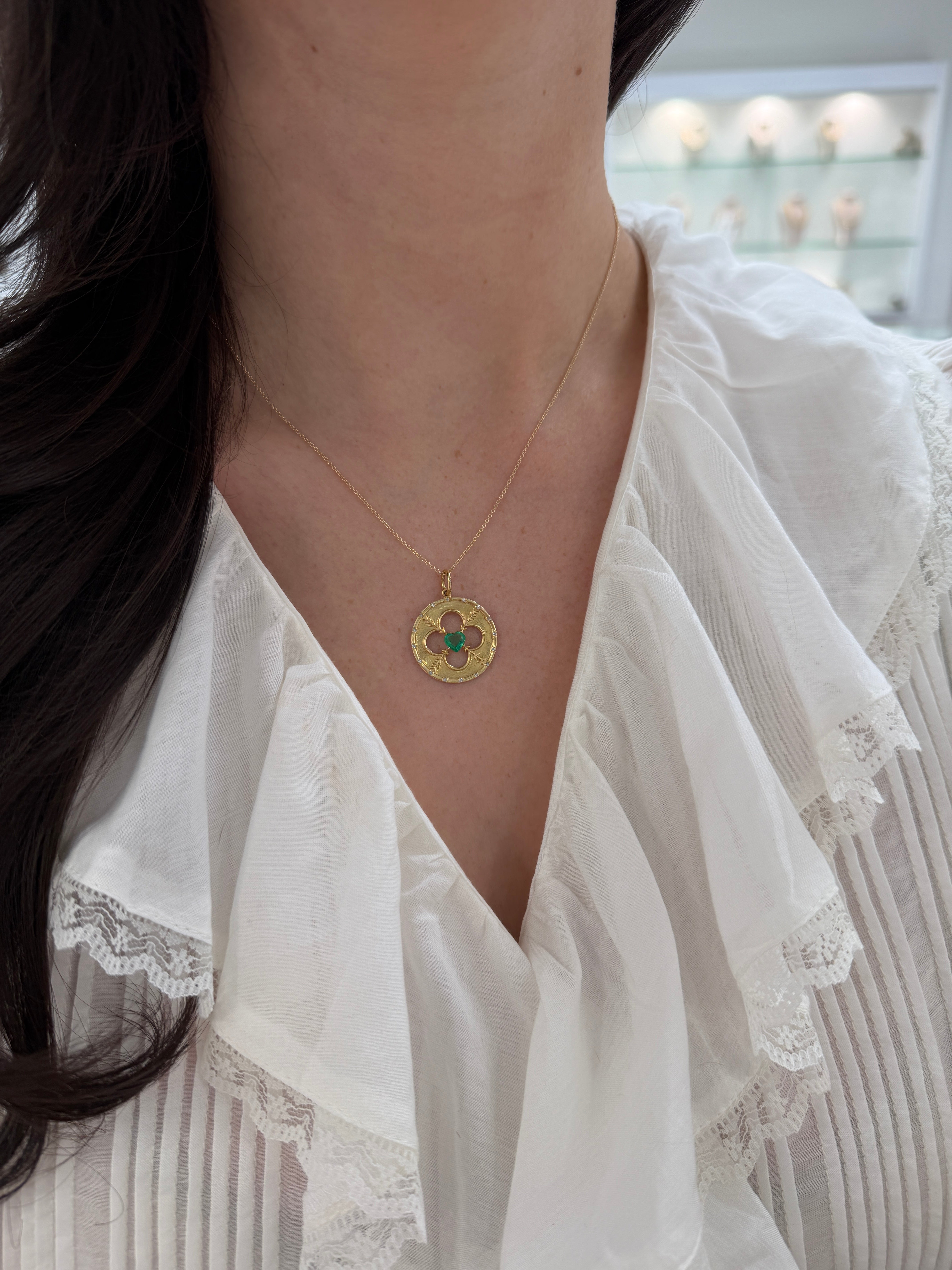 14K gold medallion pendant with natural heart-cut emerald and diamond motif, featuring 0.86 carats total weight, by JR Colombian Emeralds.
