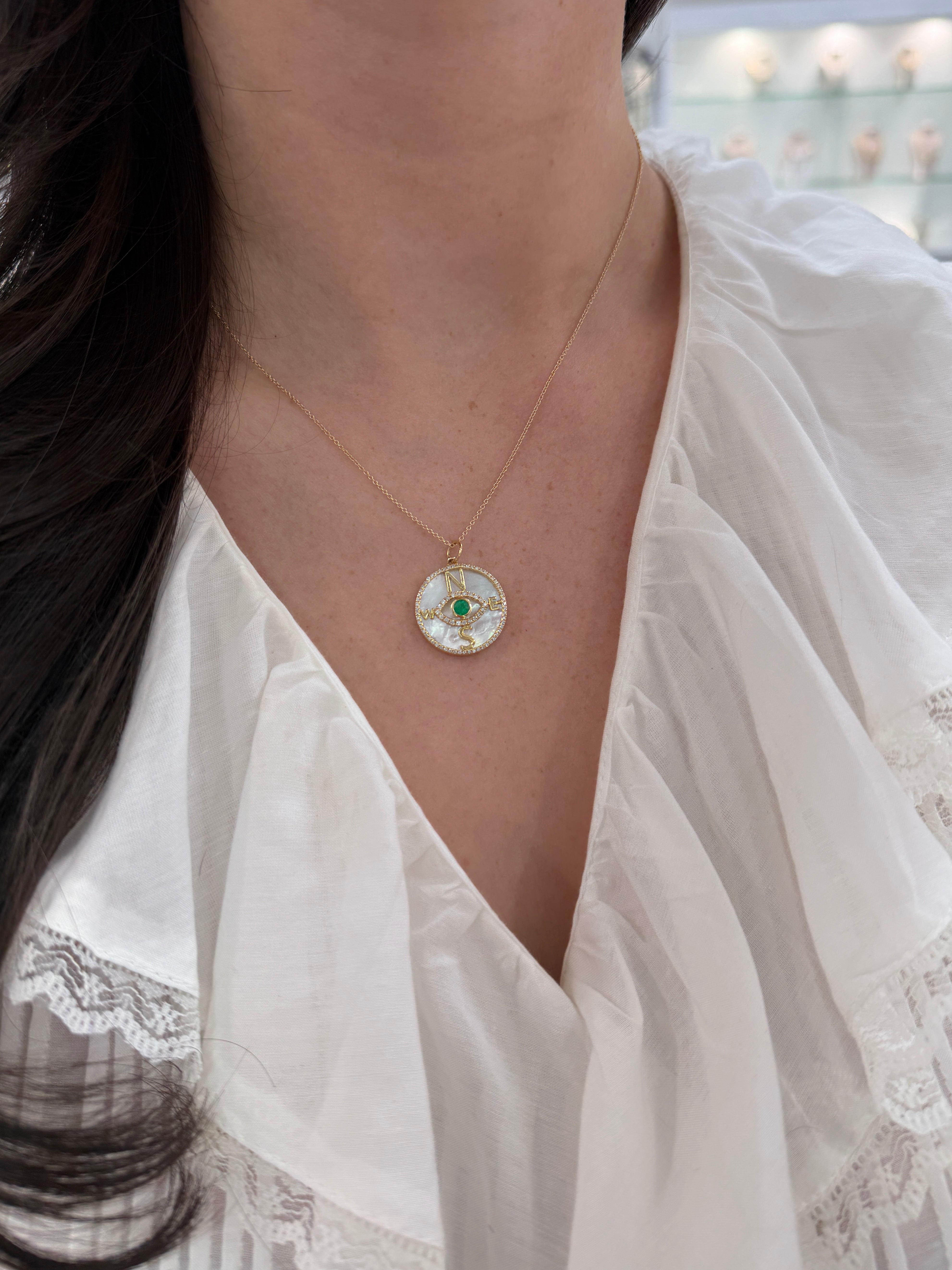 14K gold emerald and diamond mother of pearl compass evil eye pendant necklace with round gemstones, by JR Colombian Emeralds.