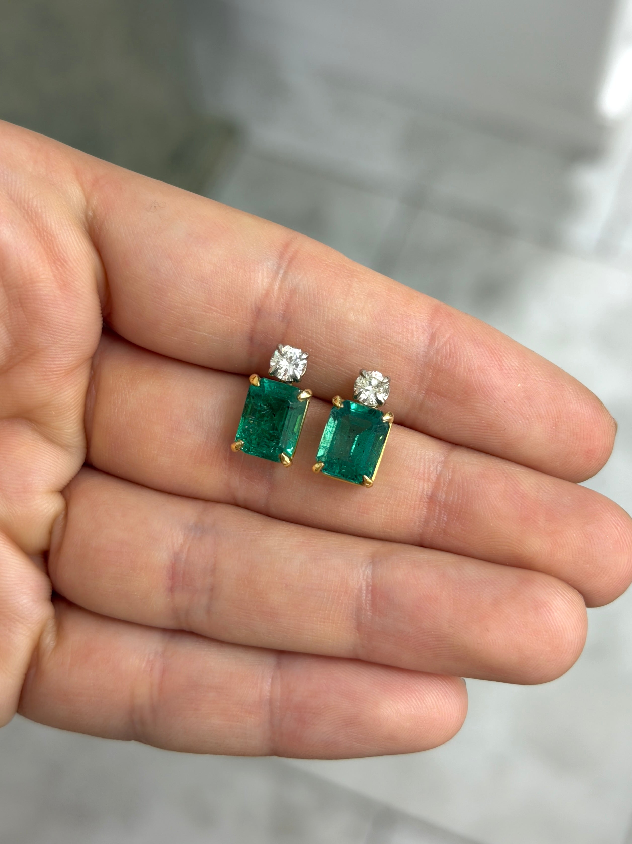 Colombian Emerald 18K two-toned earrings with vivid sea green emerald-cut and round diamonds, showcasing elegant jewelry design