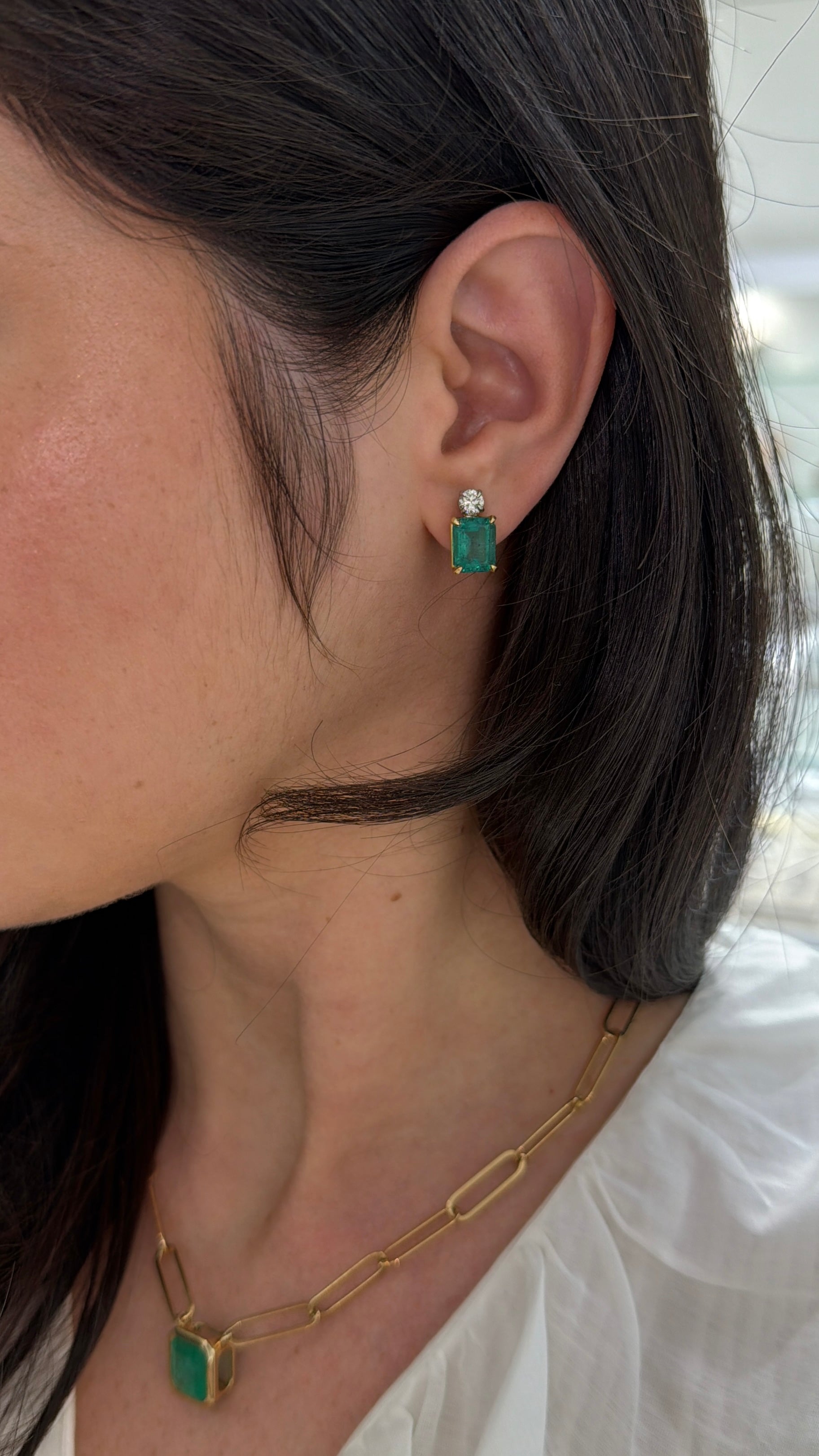 Colombian Emerald 7.20tcw 18K gold earrings with vivid bluish-green emerald-cut and round diamonds, two-tone design.