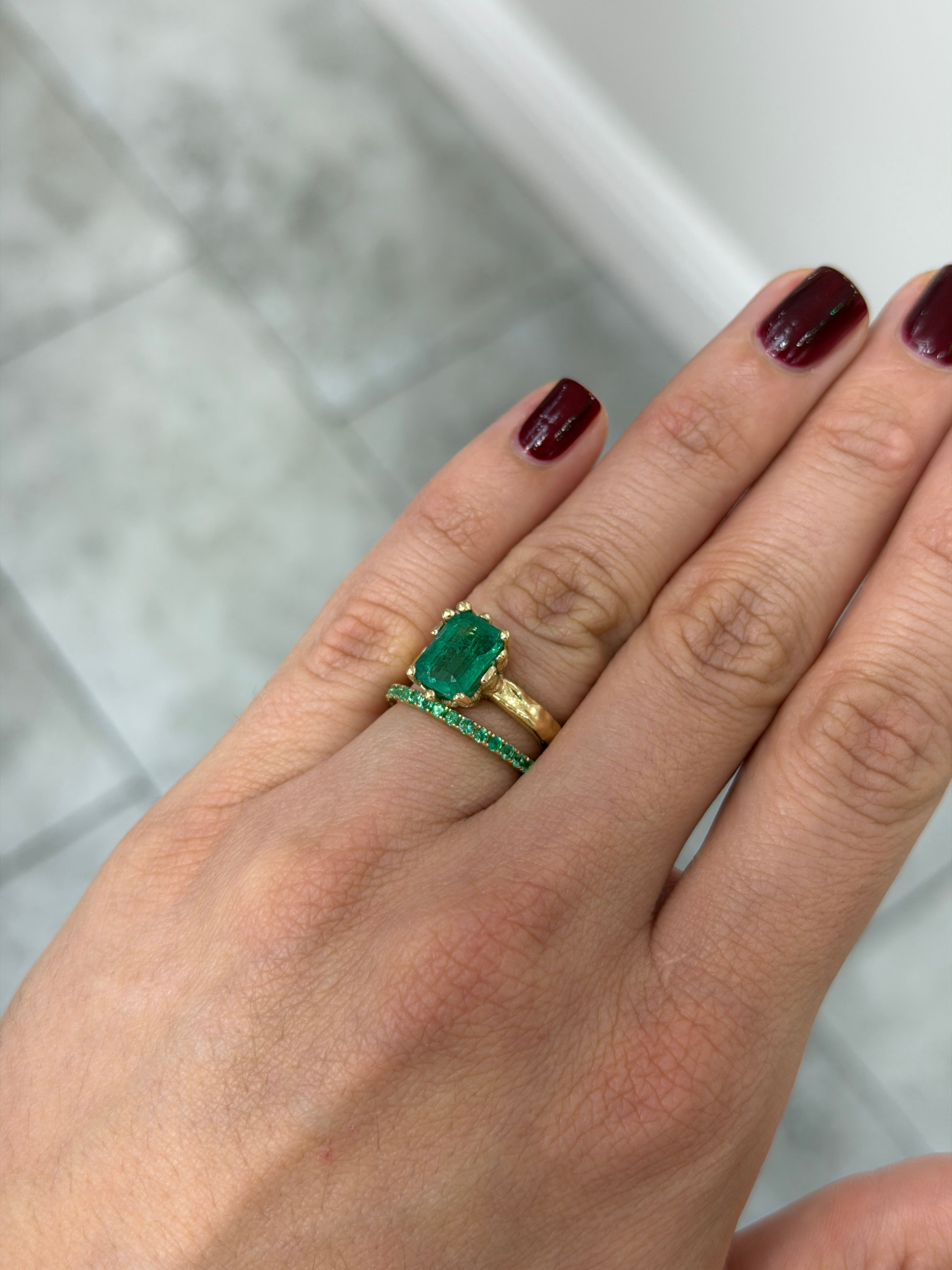 14K natural emerald eternity band with 0.70tcw, featuring sparkling green emeralds in a continuous circle, available in sizes 6-8.