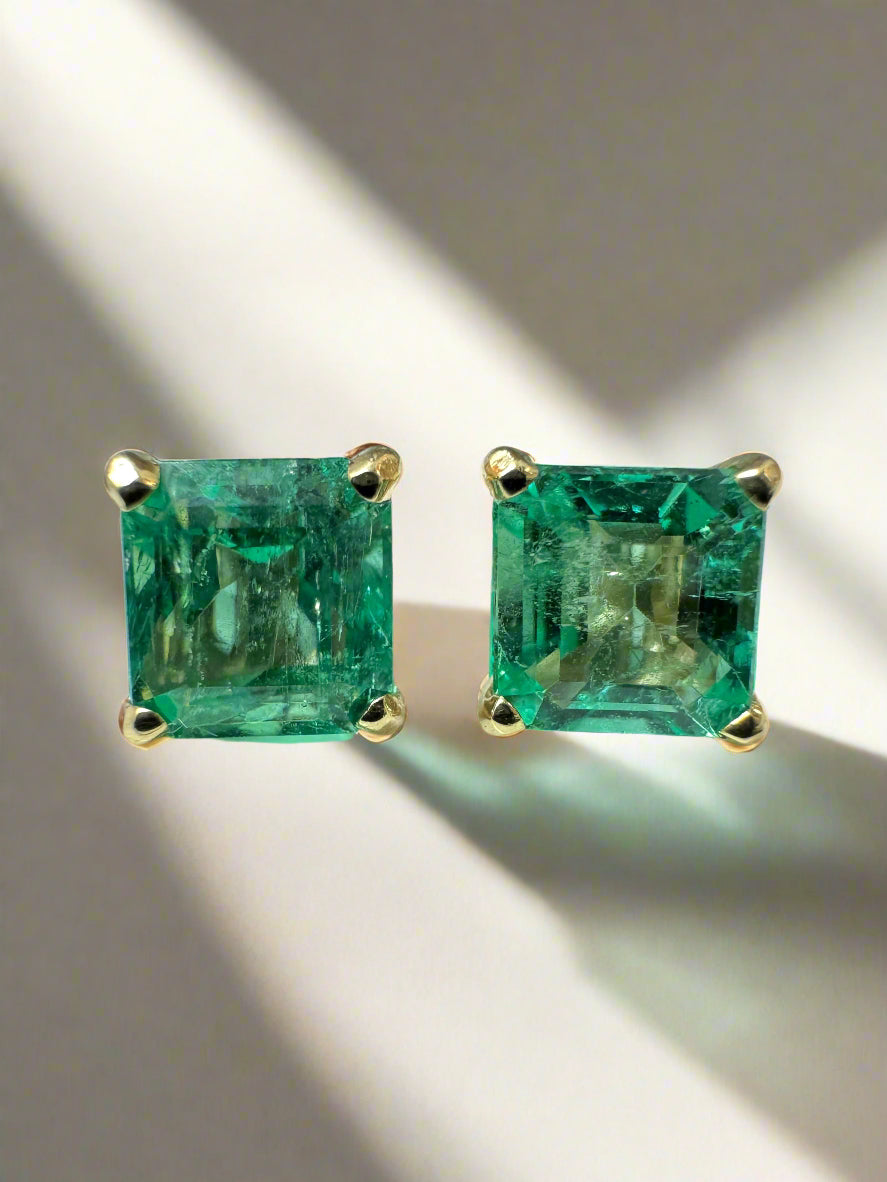 Asscher cut Colombian emerald studs in 14K yellow gold.