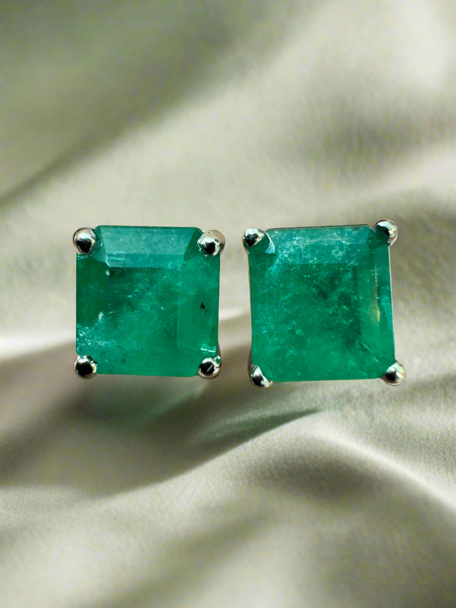 Earthy deep green Colombian emerald studs in 14K white gold.