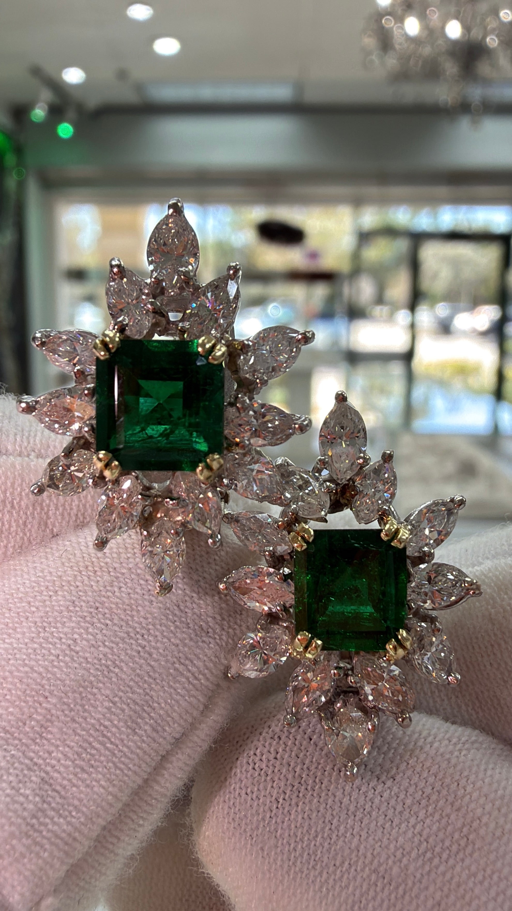18K AAA+ emerald and diamond starburst cocktail earrings featuring 7.92 carats of rich green emeralds and sparkling diamonds.