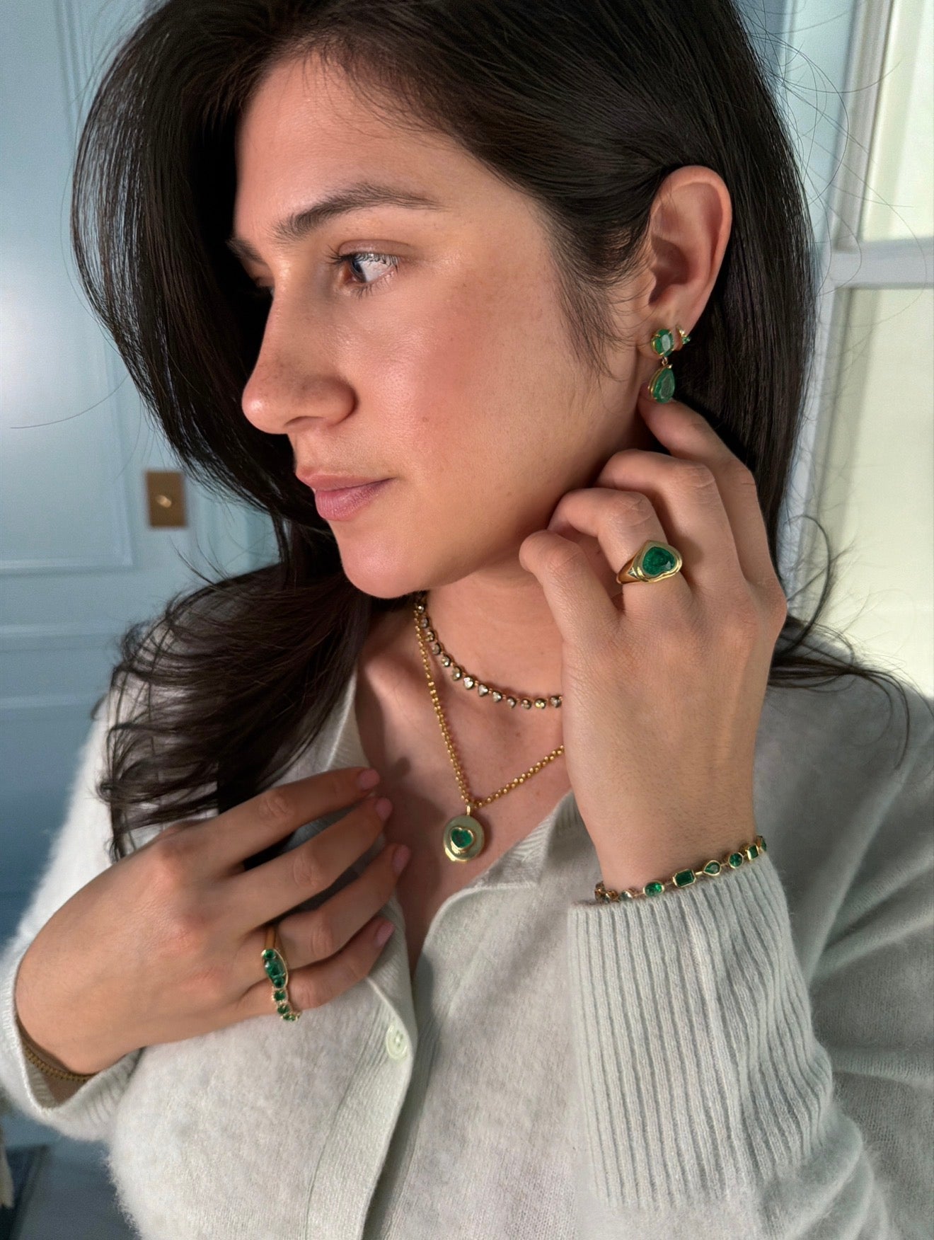 Colombian Emerald earrings with 9.78tcw dark green oval and pear-shaped emerald dangles in 18K gold, showcasing vibrant gemstones.