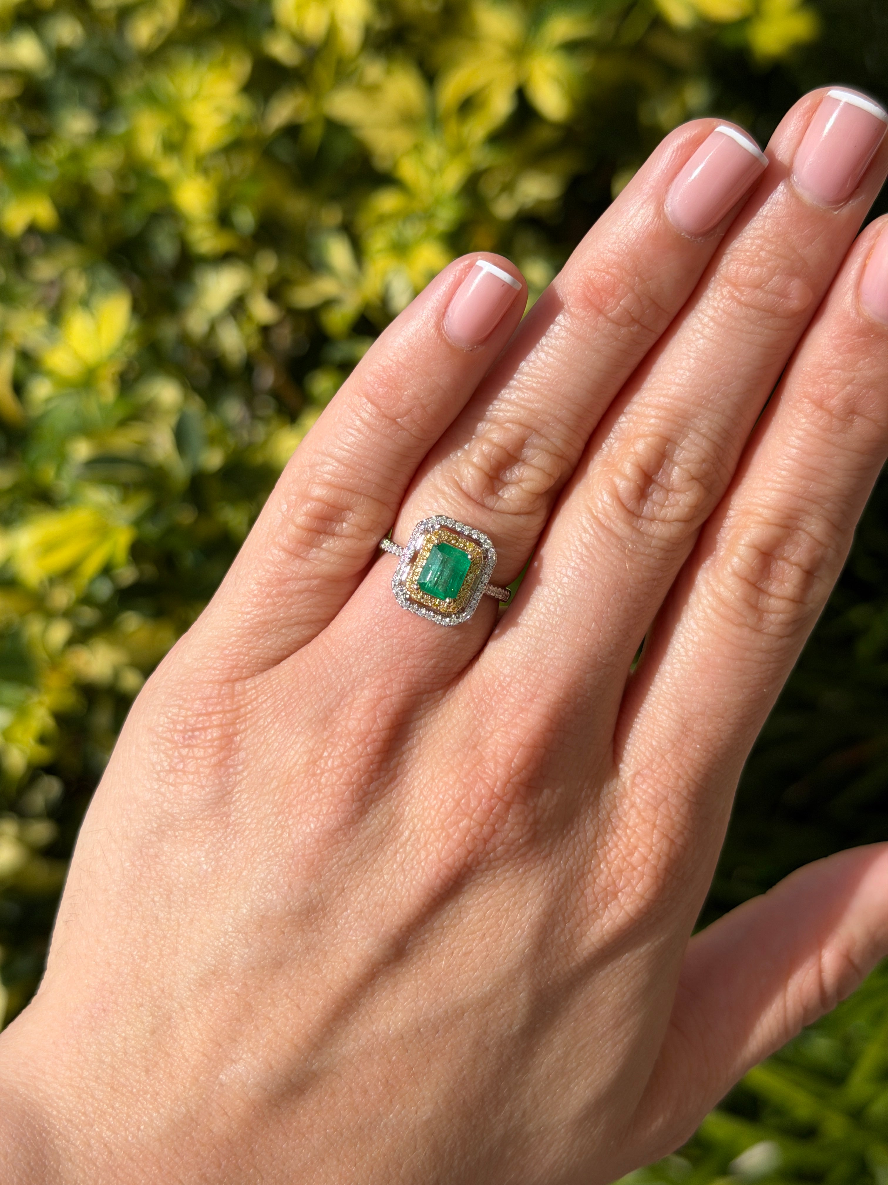 14K yellow gold halo ring with 1.65tcw Colombian emerald and yellow diamond accents, showcasing a stunning gemstone centerpiece.