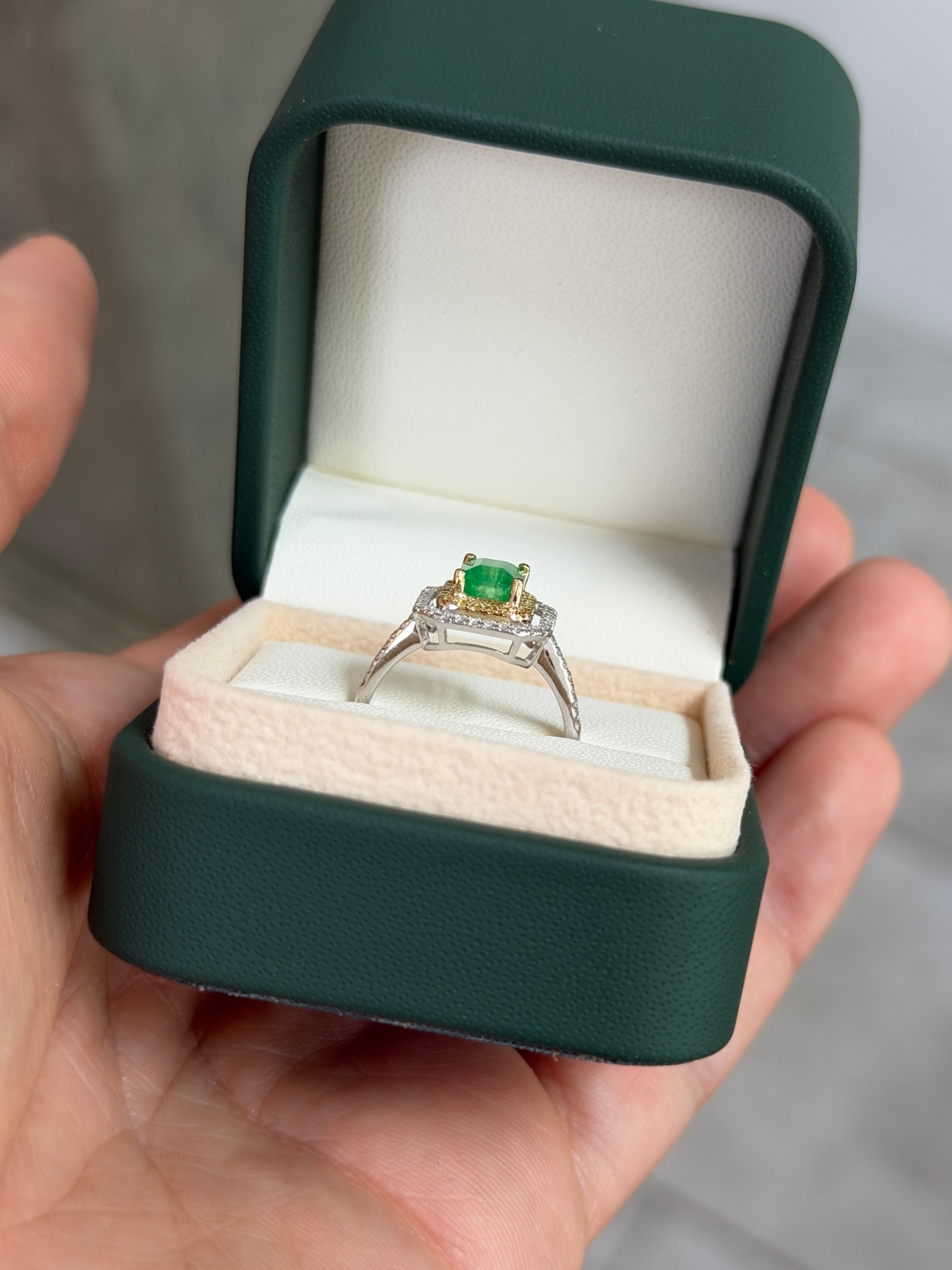 14K gold Colombian emerald and yellow diamond halo ring featuring a 1.65 carat total weight gemstone with intricate setting.